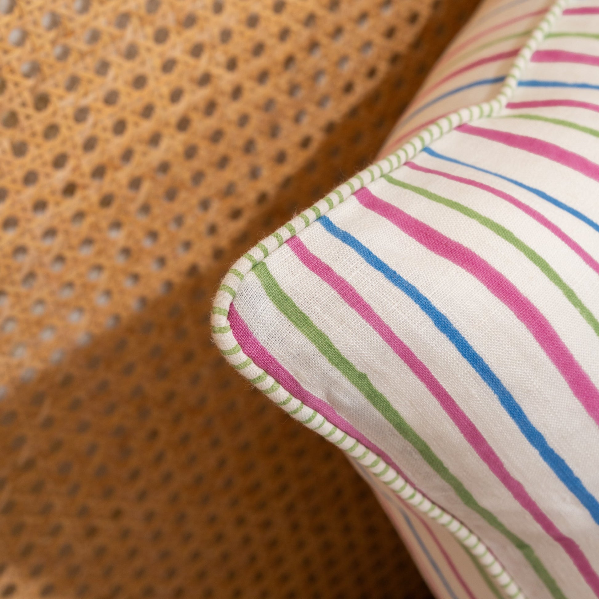 Close-up of a fabric with colorful stripes on a textured brown background