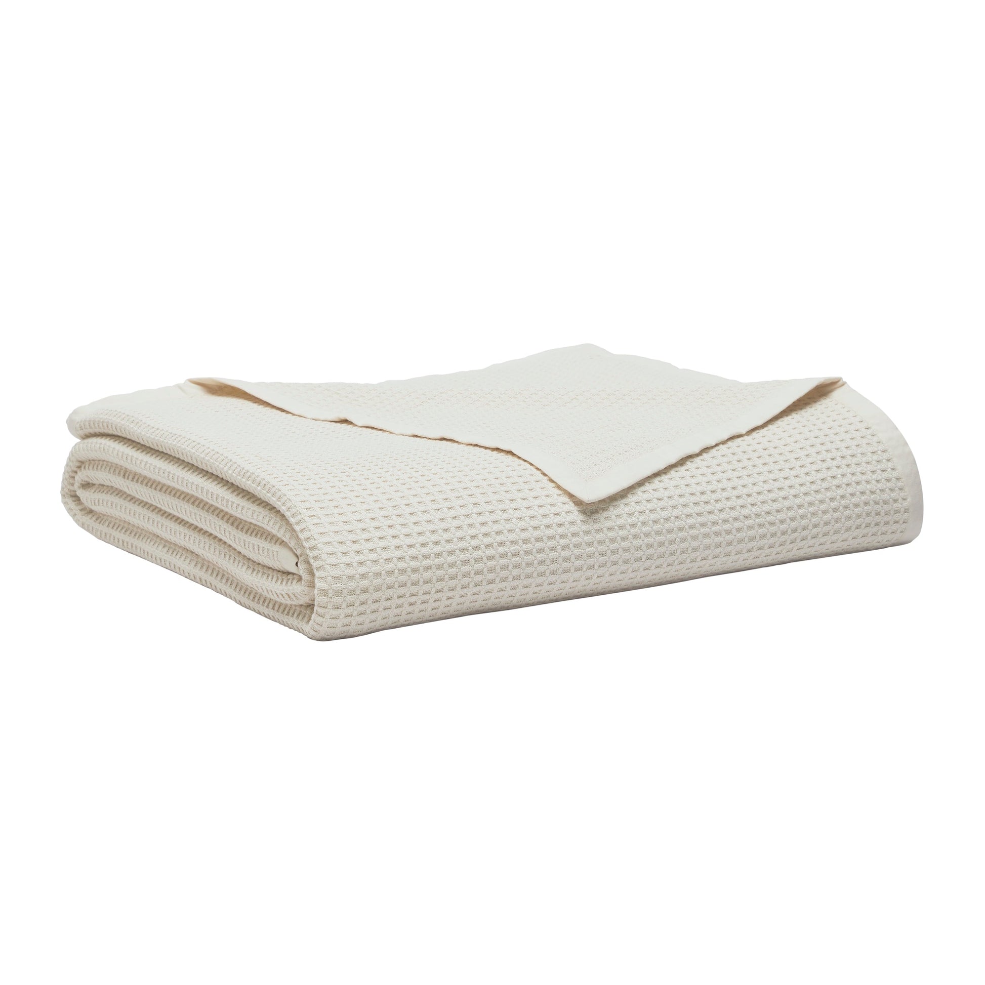BL-867-9496_2|Folded cream waffle weave blanket. Soft, breathable cotton throw blanket for bed or sofa, adding texture and warmth to any room.