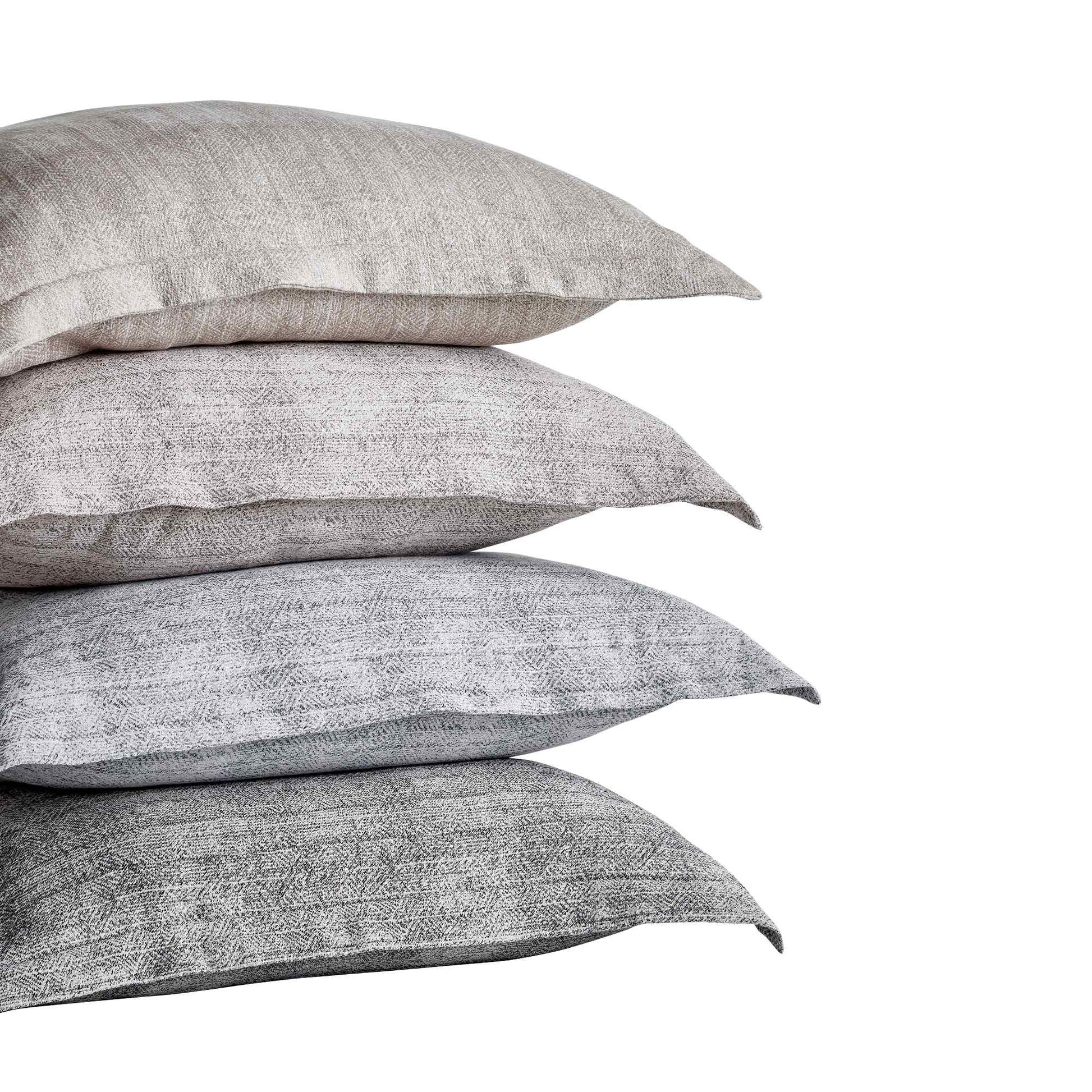 KS-033-2036_2|Stacked textured pillow shams in varying shades of grey, complementing the modern duvet cover for diverse bedroom decor.