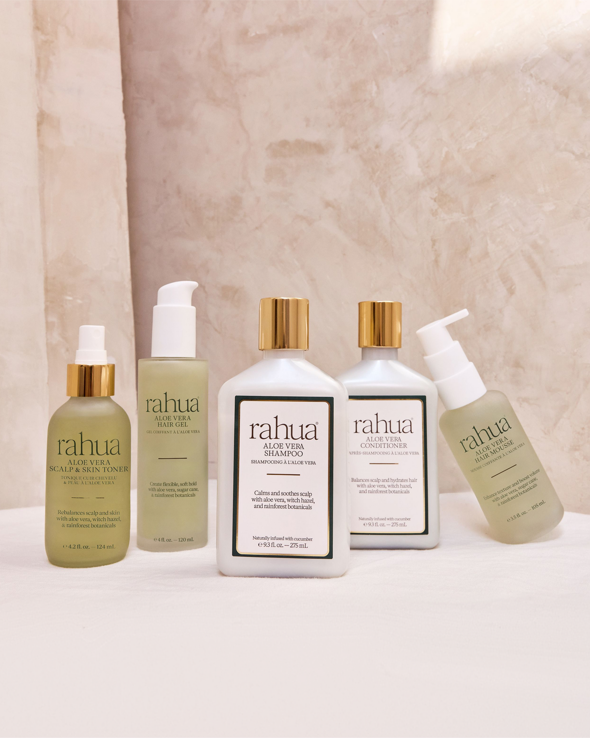 Collection of Rahua hair care products on a neutral background|variant:42-oz