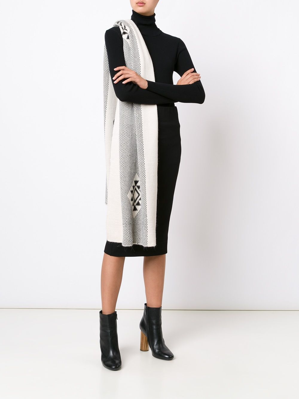 Model wearing Estrella Shawl draped over shoulder, black dress, and ankle boots.