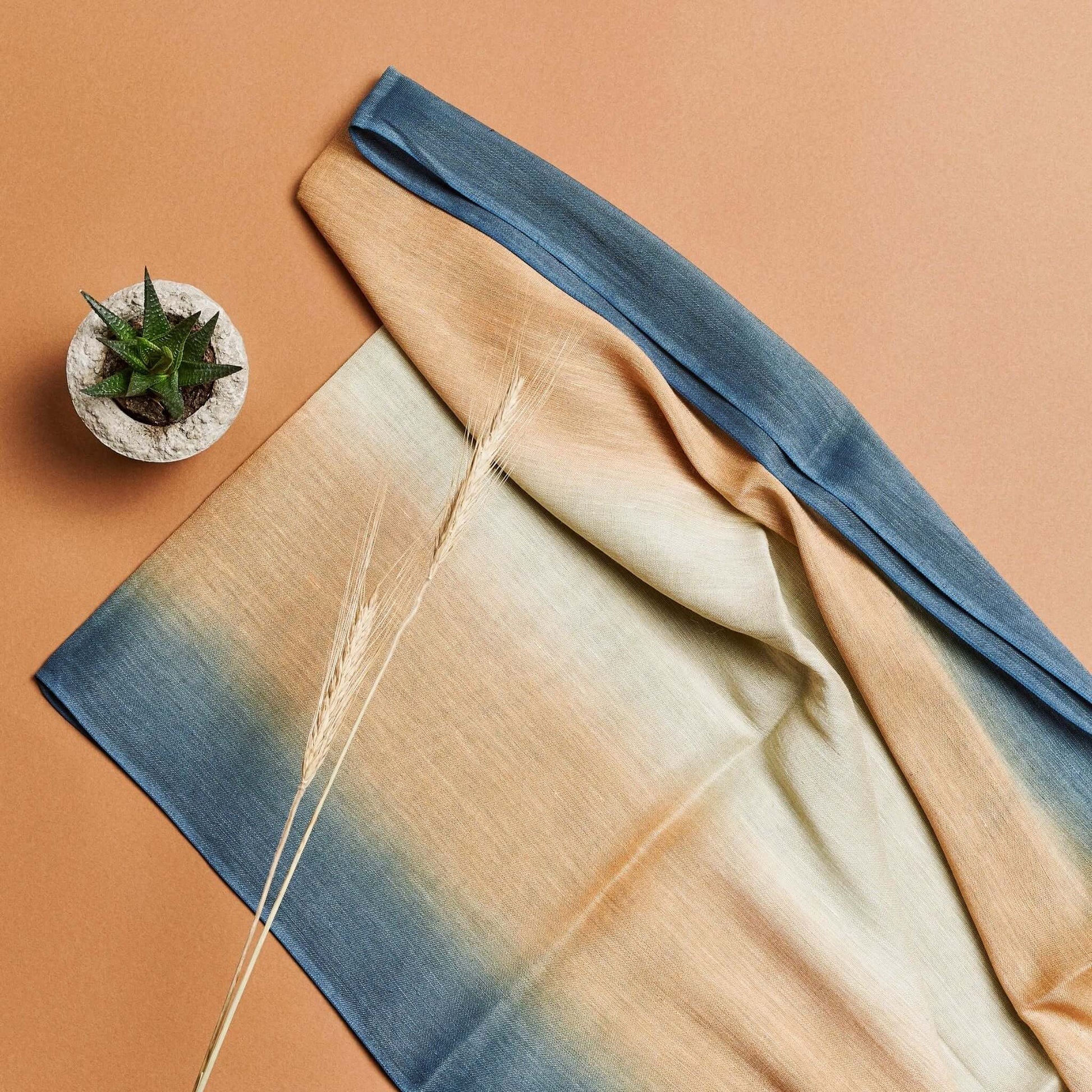 Oceana Beige Soft Linen Silk Handloom Scarf displayed on a beige background with a small plant.