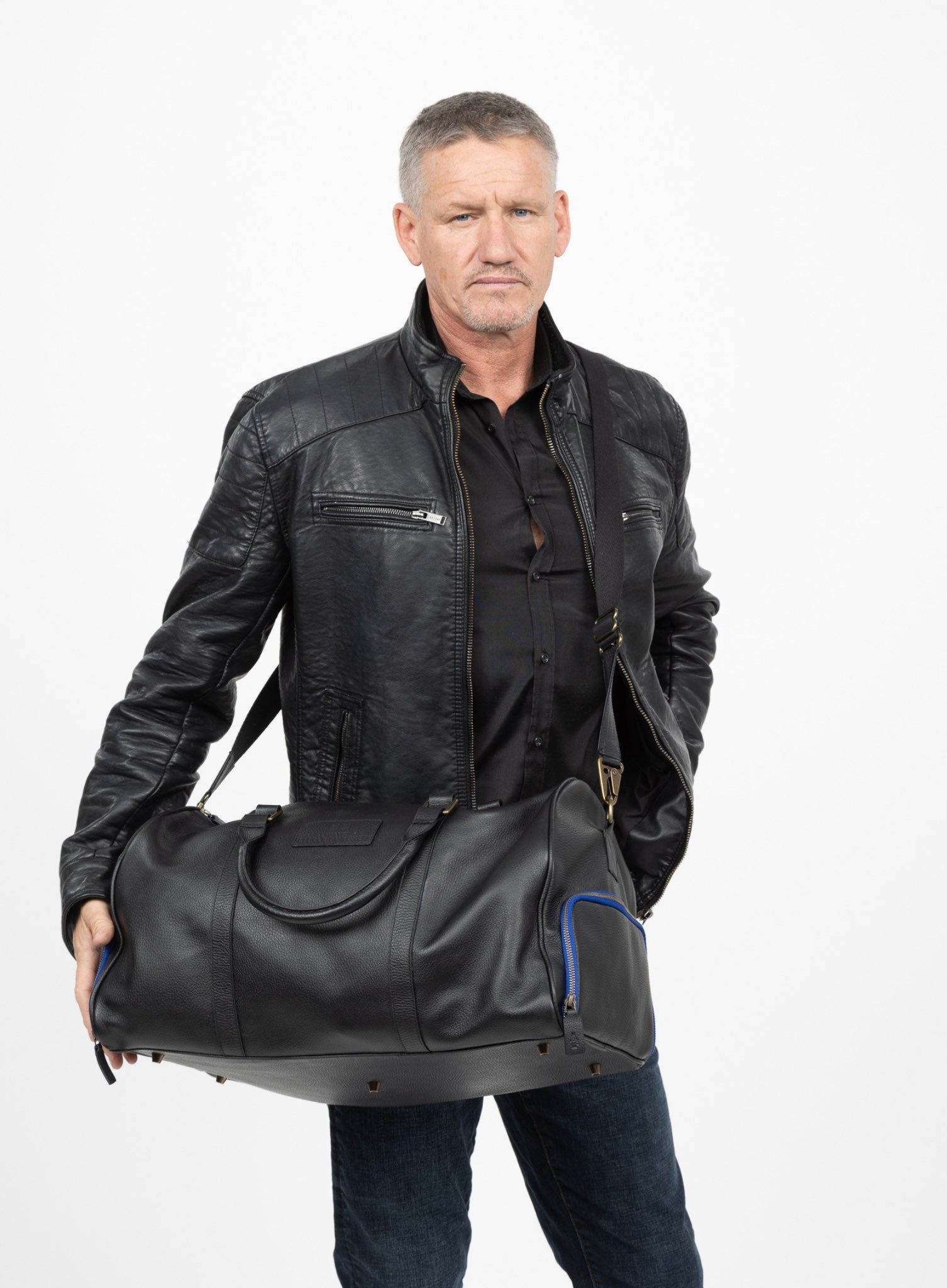 mission essential duffle bag in black displayed by model side-view.