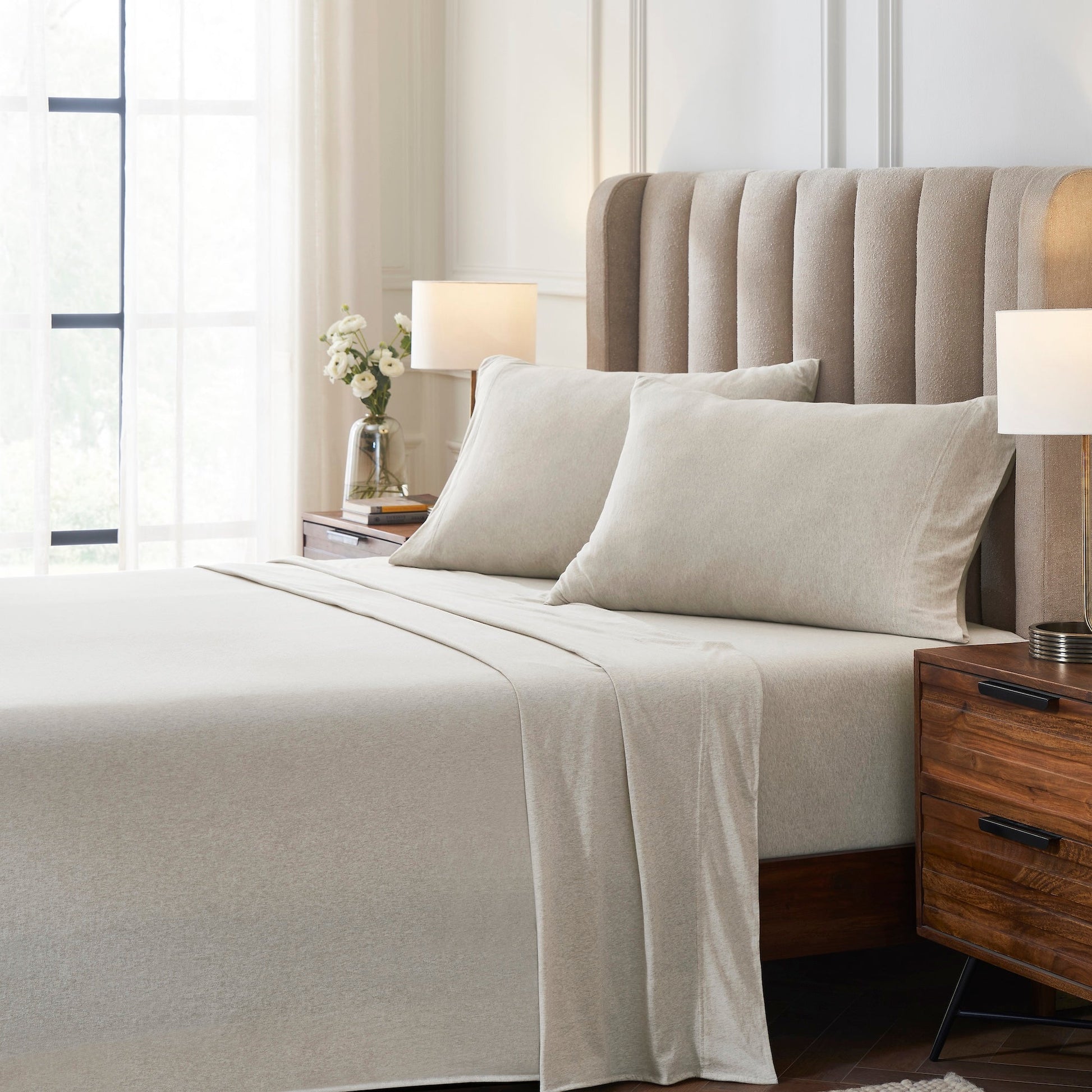 CSS-527-7284_3|Neatly made bed featuring a light beige melange 100% cotton sheet set, offering breathable and soft comfort.