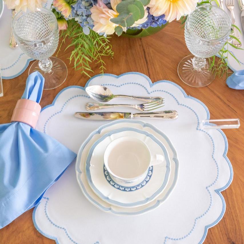 The blue Victoria impermeable placemat with Victorian-style border detail by Talah Home