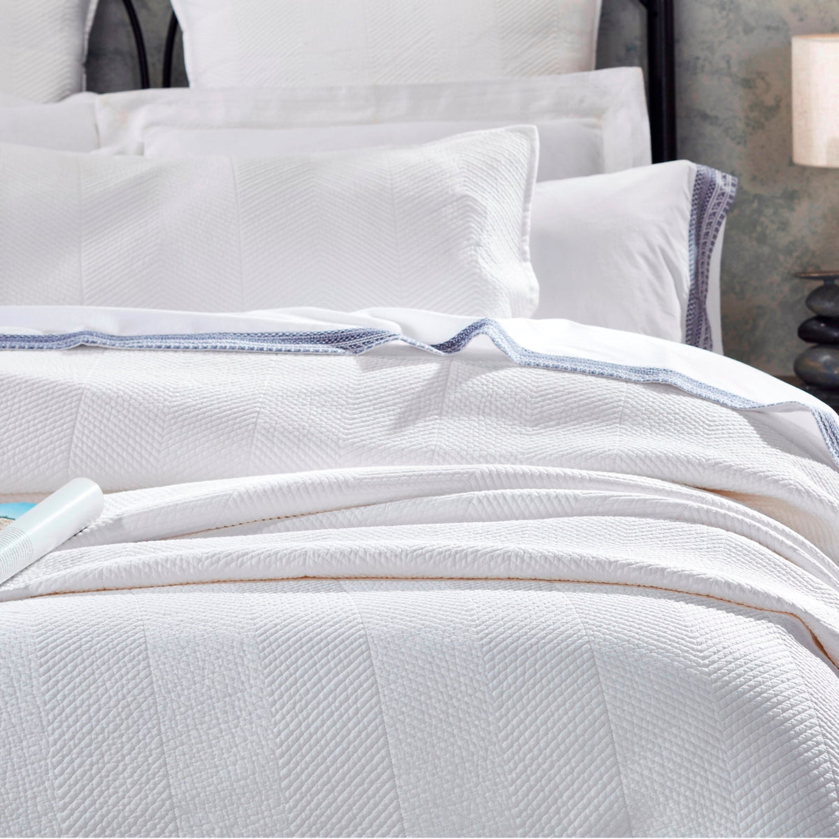 CL-170-9496_5|Pristine white chevron textured coverlet neatly folded, providing a clean, elegant, and modern bedding solution.