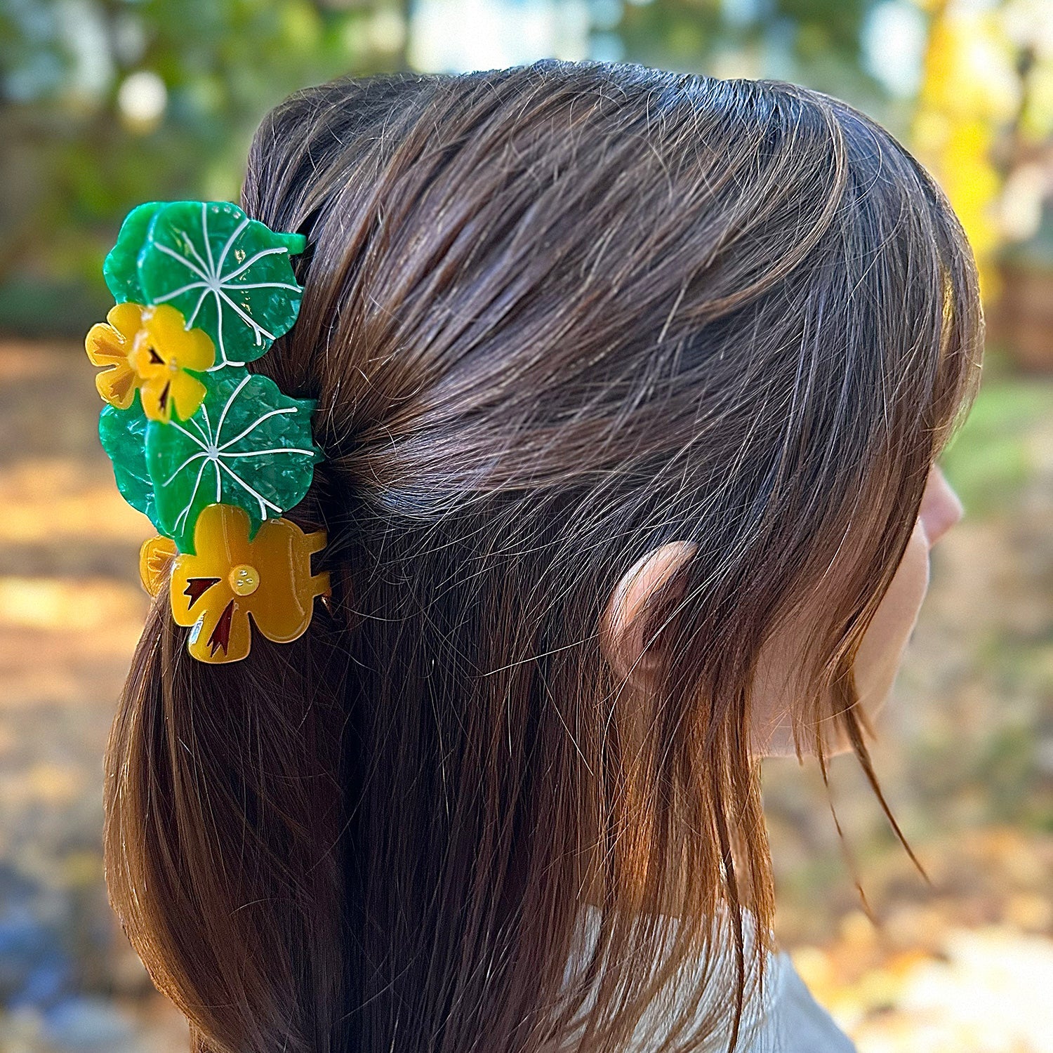 Green leaves and orange flowers nasturtium garden hair claw will bloom in your wardrobe as it blooms in spring in california from Centinelle. Handmade on cellulose acetate, with splice technique, exquisite miniature details and crystals, that are tied directly to its value and make them unique and special. 