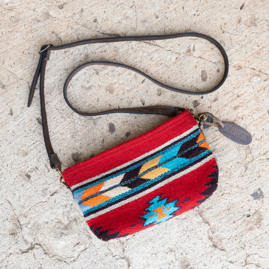 Handwoven convertible clutch with Zapotec pattern in bold colors; can be used as a pouch, wristlet, or crossbody with included leather straps and internal pocket.