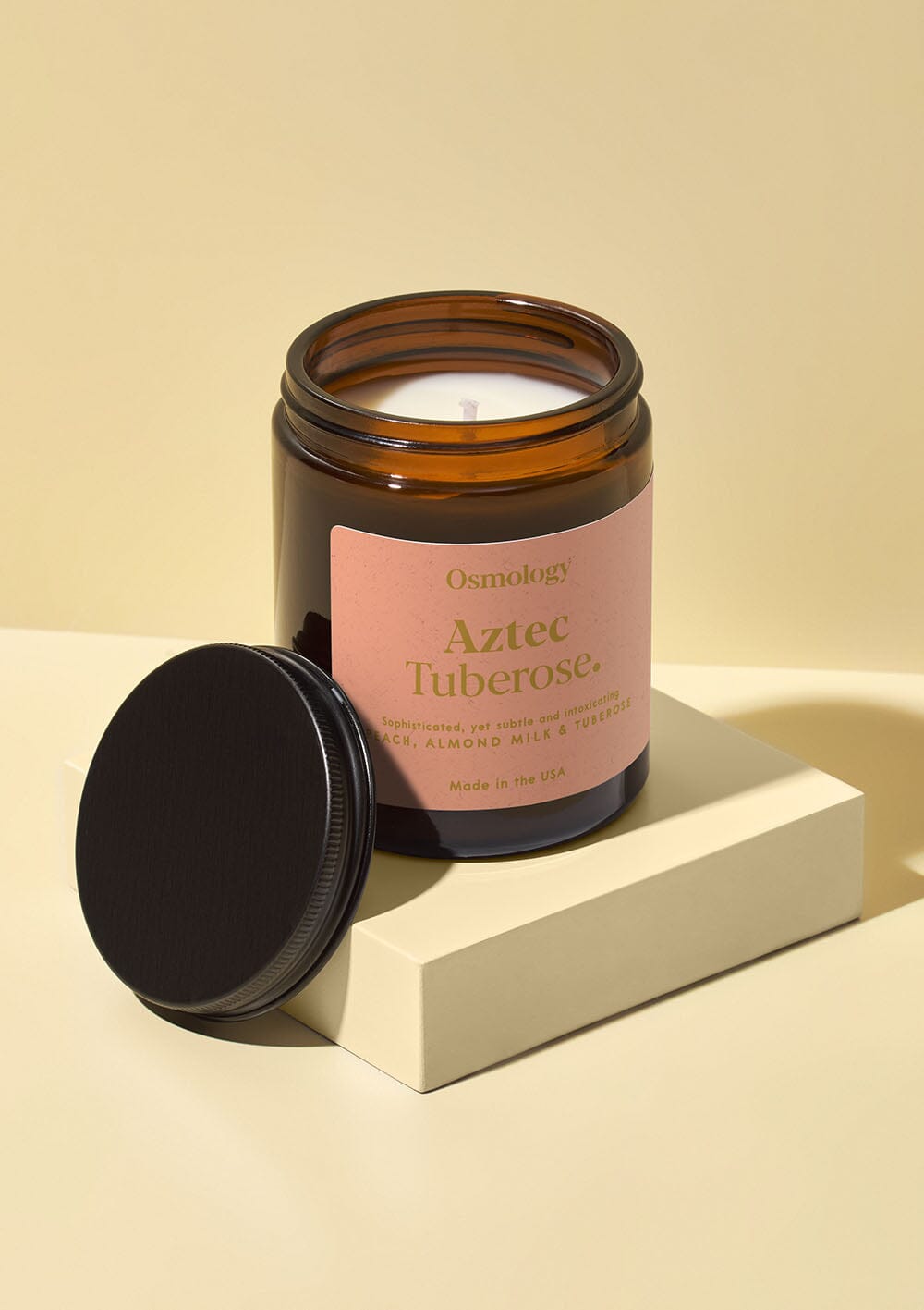 Osmology Aztec Tuberose scented jar candle with lid on white background