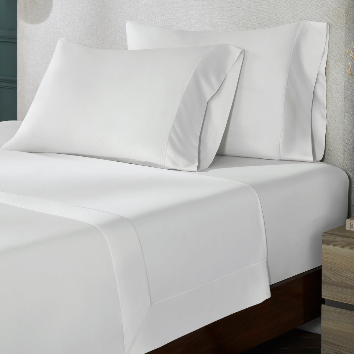 TFL-546-3980_2|Close-up of smooth white 100% cotton sheets and pillowcases. Soft sateen weave bedding, perfect for restful sleep.