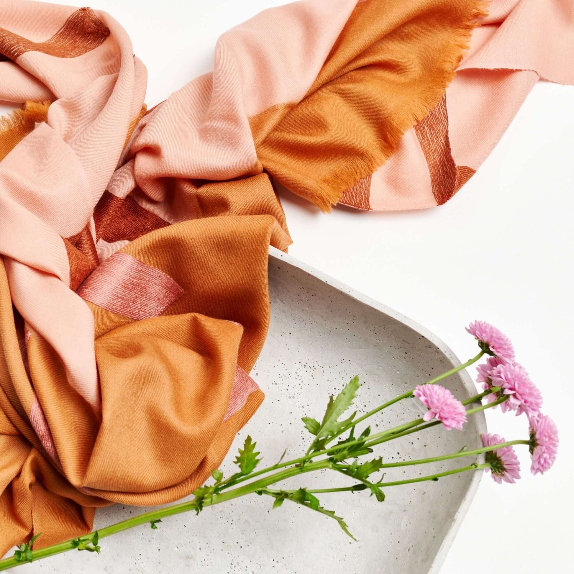 Canyon Hand Embroidered Hand Woven Merino Silk Soft Scarf displayed with flowers in a modern setting.