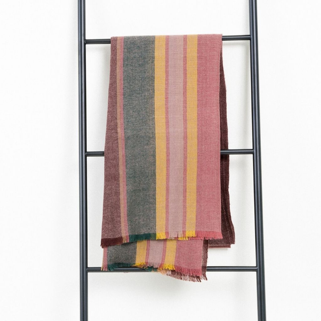 Barque Clay Modern Artisan Striped Soft Merino Handwoven Scarf hanging on a ladder display.