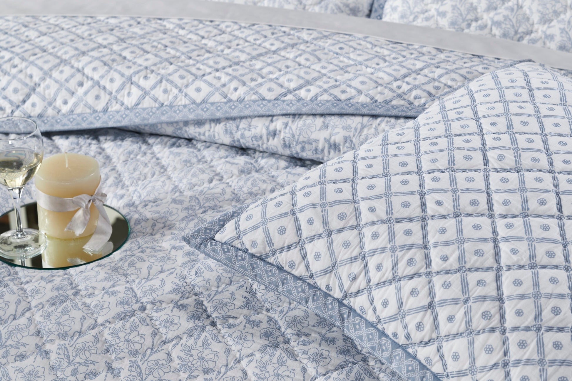 QT-345-11096_4|Close-up of light blue patterned quilt with diamond stitching, featuring elegant floral and geometric designs.