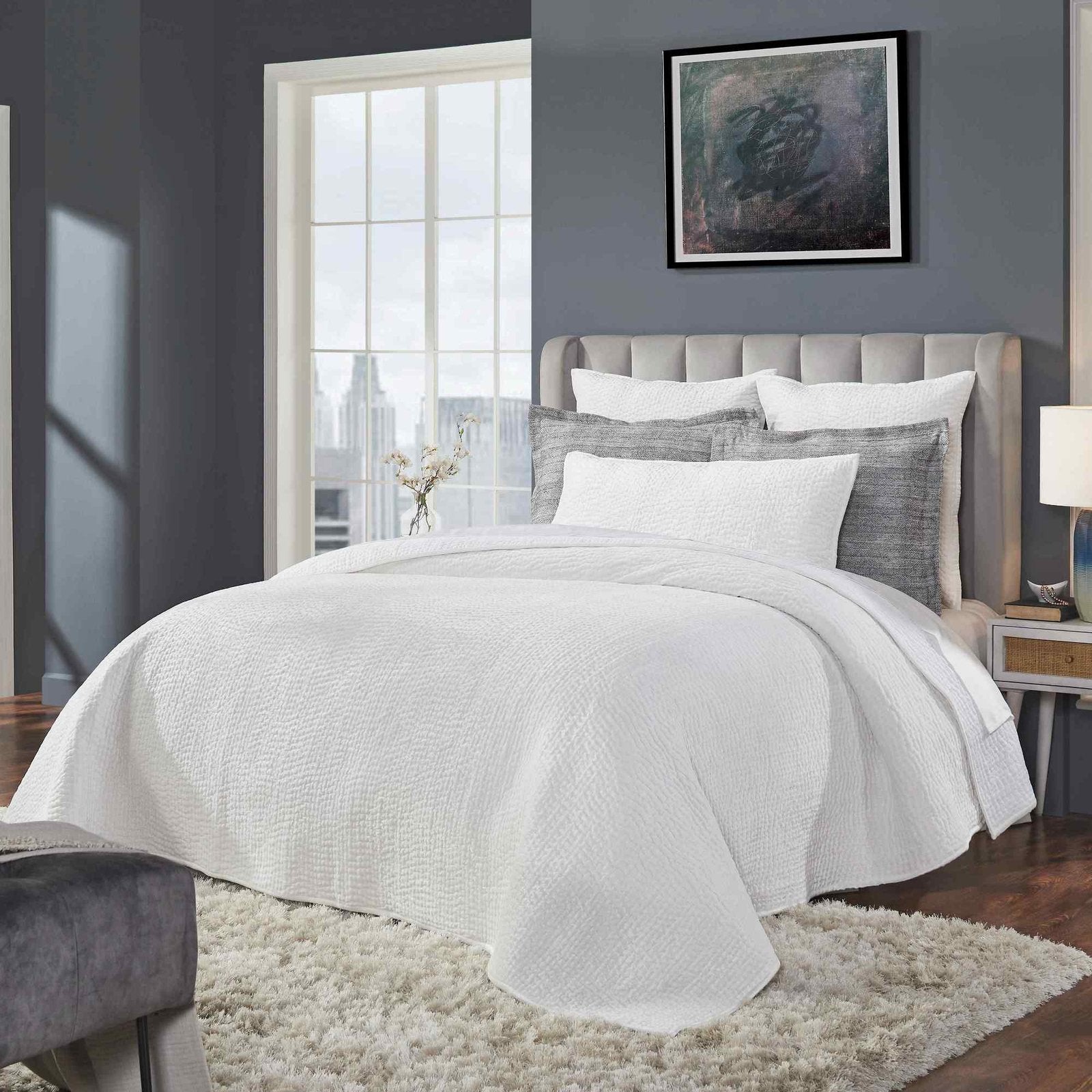 CL-182-9496-LOT1_3|Crisp white quilted coverlet with a subtle grid pattern on a stylish bed, perfect for modern bedroom aesthetics.