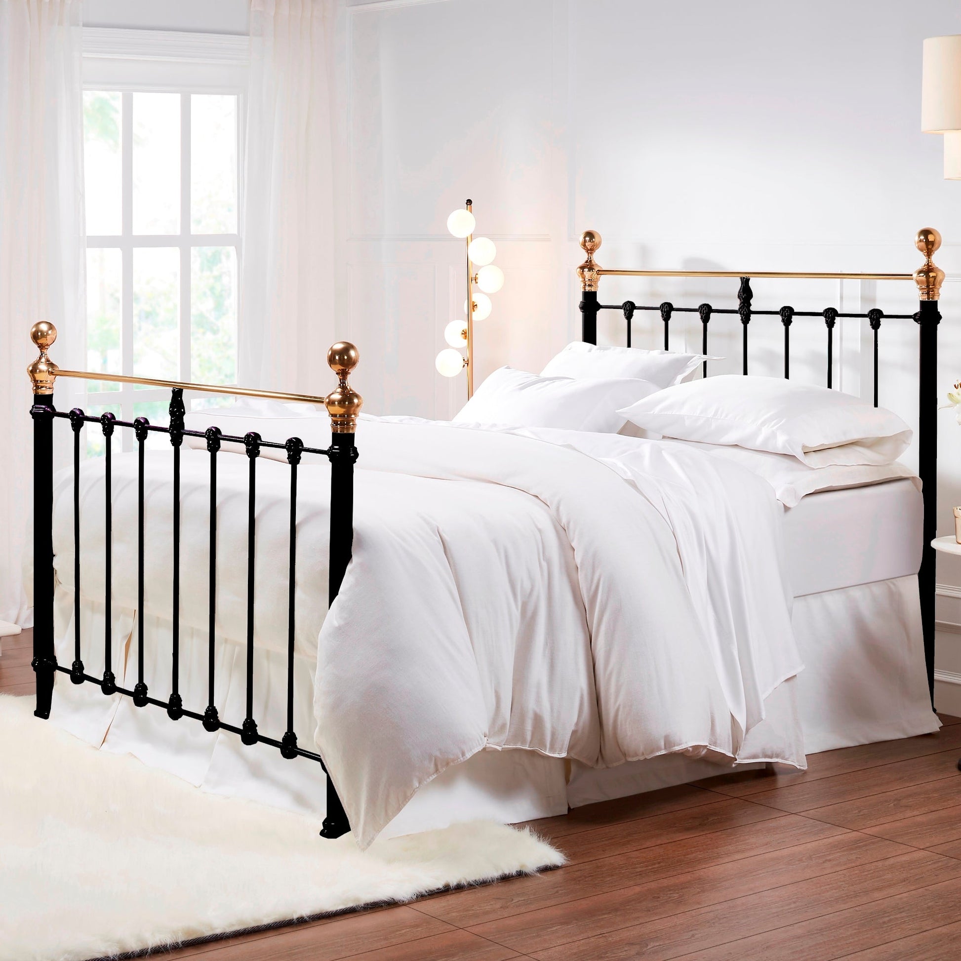 MB-205-X_1|Classic black metal bed frame with brass accents, paired with crisp white bedding for a timeless aesthetic.