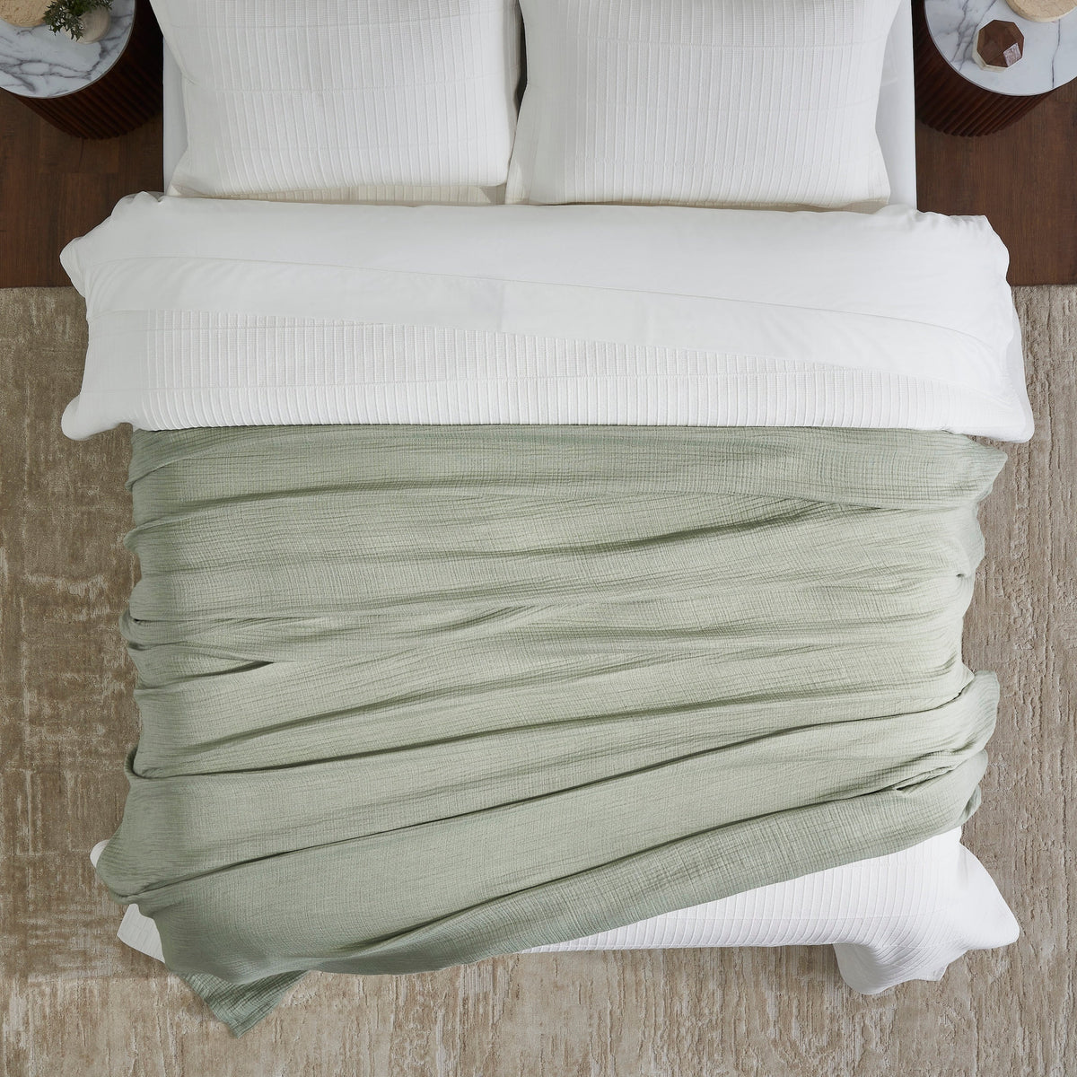 BL-864-9496_4|Soft sage green textured blanket draped elegantly over a crisp white bed, enhancing bedroom decor with cozy, natural charm.