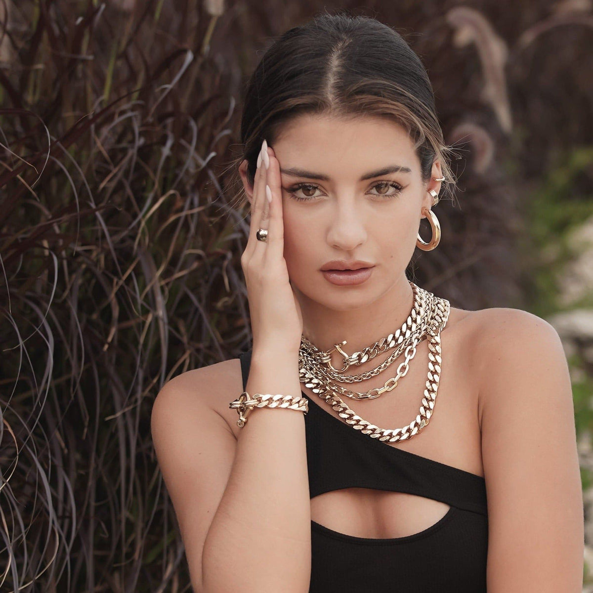 Woman wearing gold Lennon Necklace showcasing stylish jewelry look