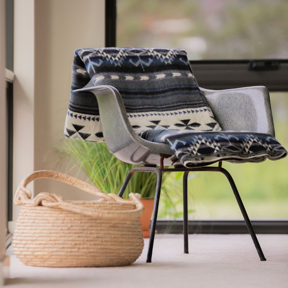 Black artisanal woven throw on table