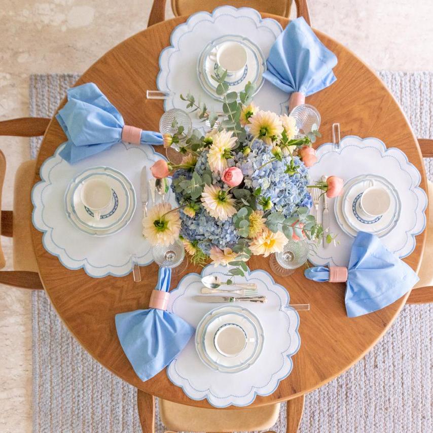 The blue Victoria impermeable placemat with Victorian-style border detail by Talah Home