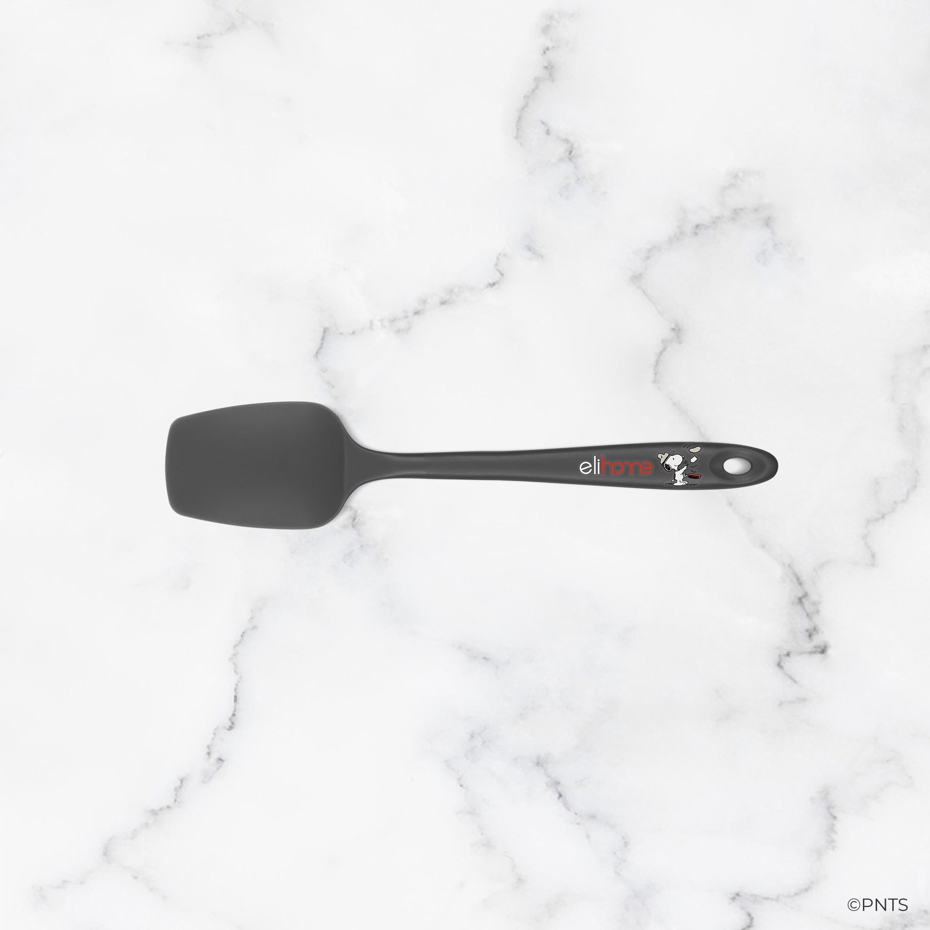 Black spatula on a white marble background