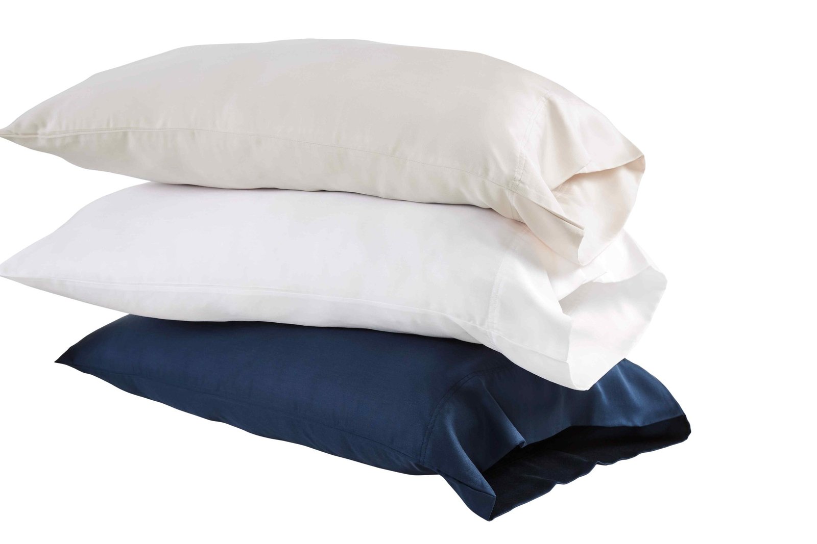 AKP-509-2040_2|Stack of three 100% Lyocell pillowcases: beige, white, navy. Cooling, soft sateen finish for luxury bedding. (119)
