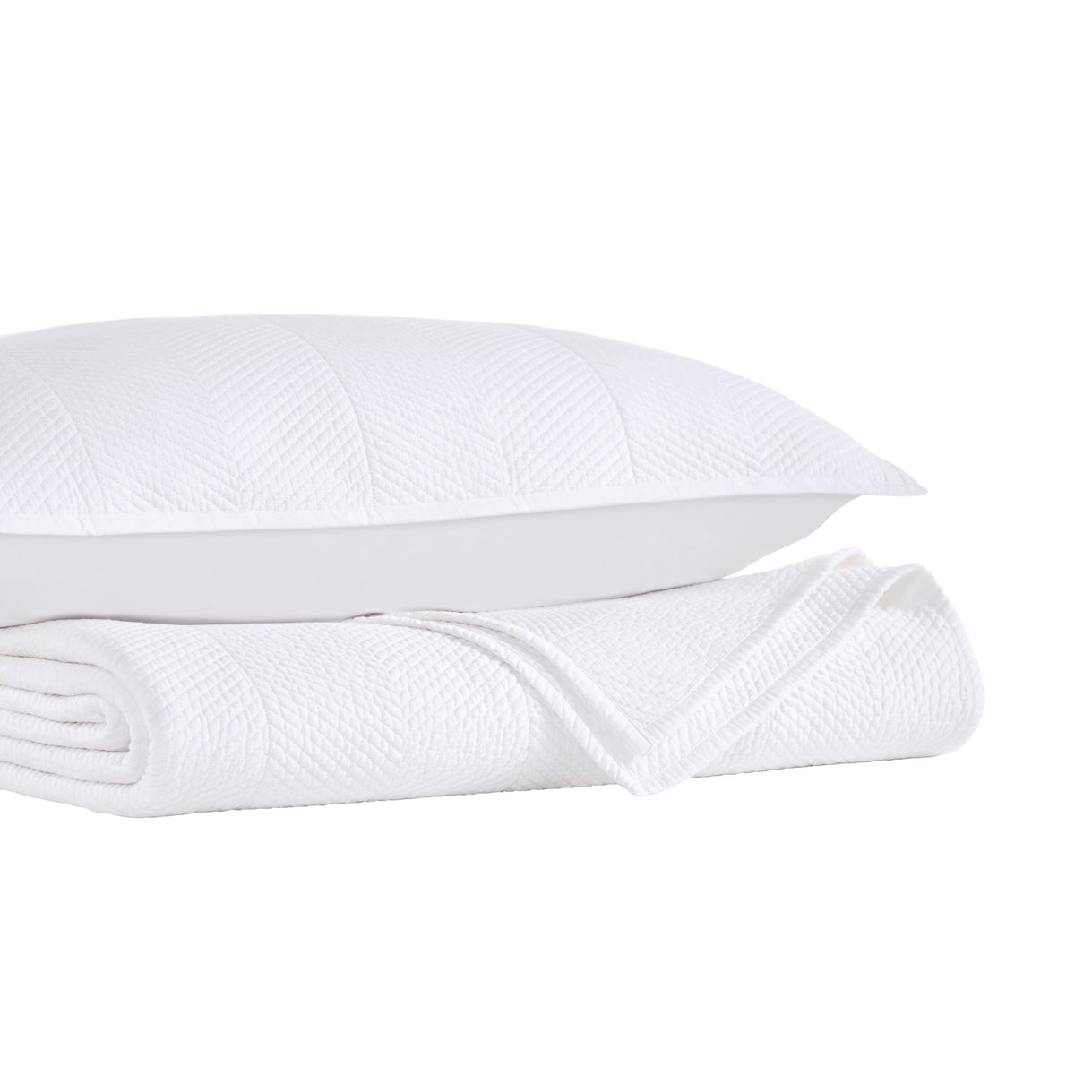 CL-170-11096_9|White chevron textured coverlet folded beside a matching pillow, offering a complete and elegant bedding set.