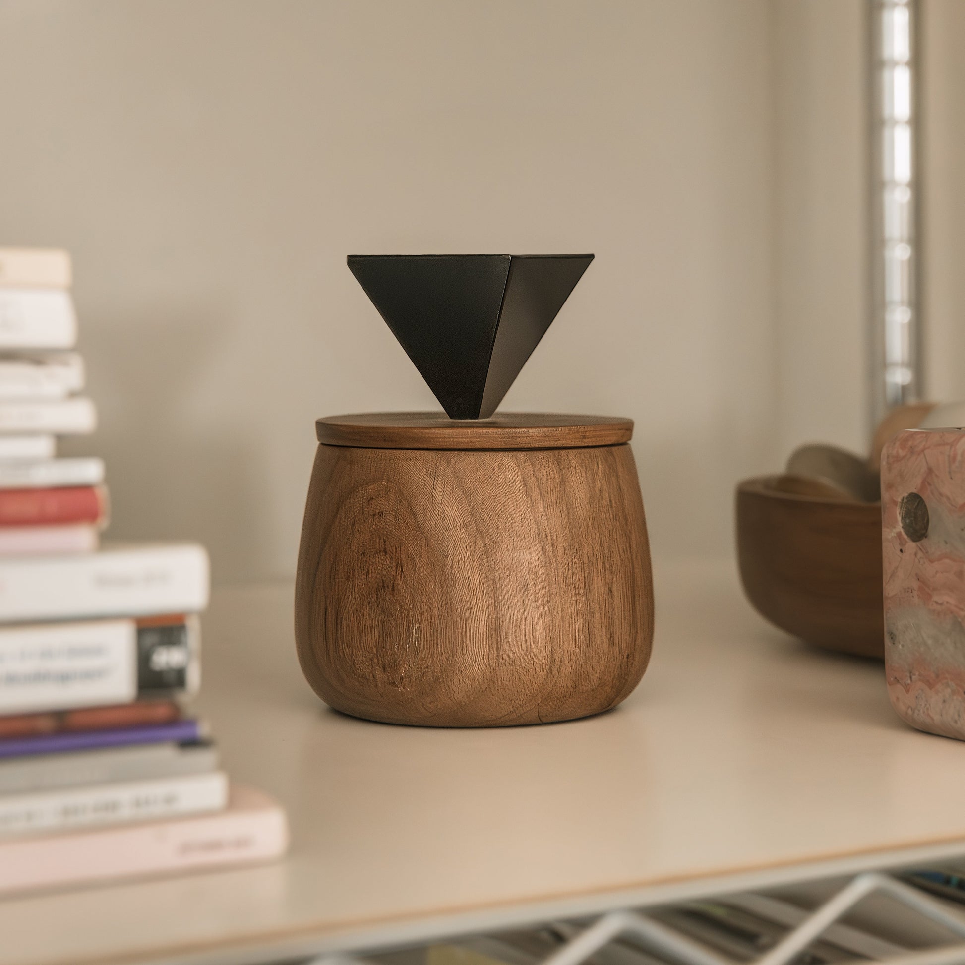 Handcrafted black onyx round jewel box serving as an elegant slow design storage piece in a modern interior.