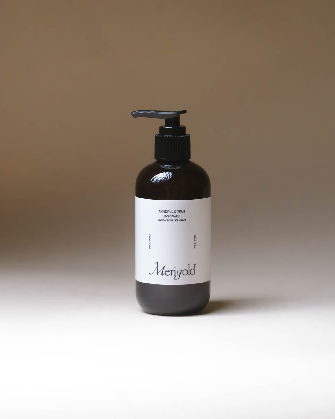 Merigold Mindful Citrus Hand Wash in amber pump bottle, gentle citrus cleansing soap on minimal neutral backdrop.