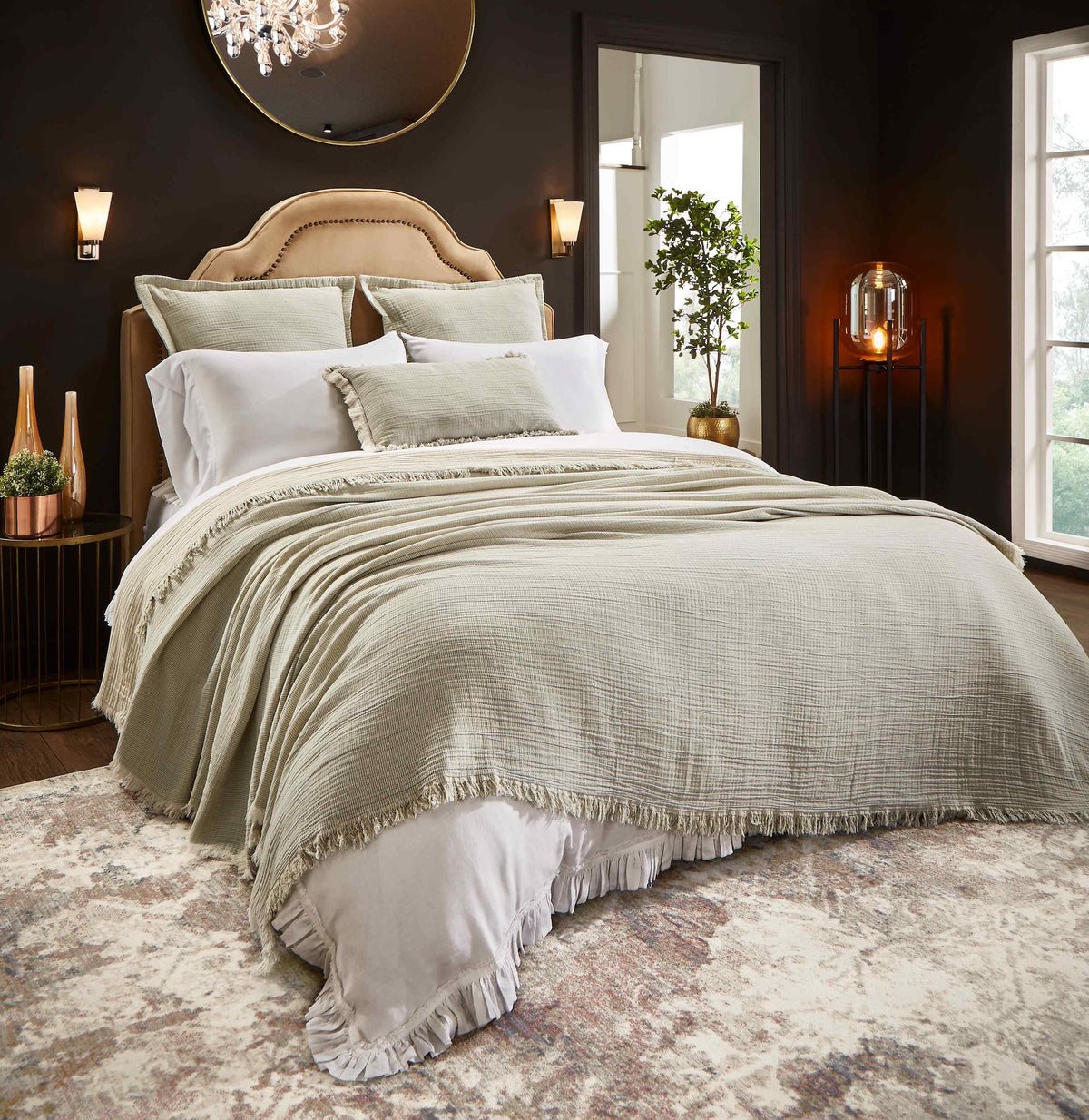 BT-111-11096_2|Elegant, textured sage green blanket with fringe detail covers a luxurious bed, enhancing bedroom comfort and style.