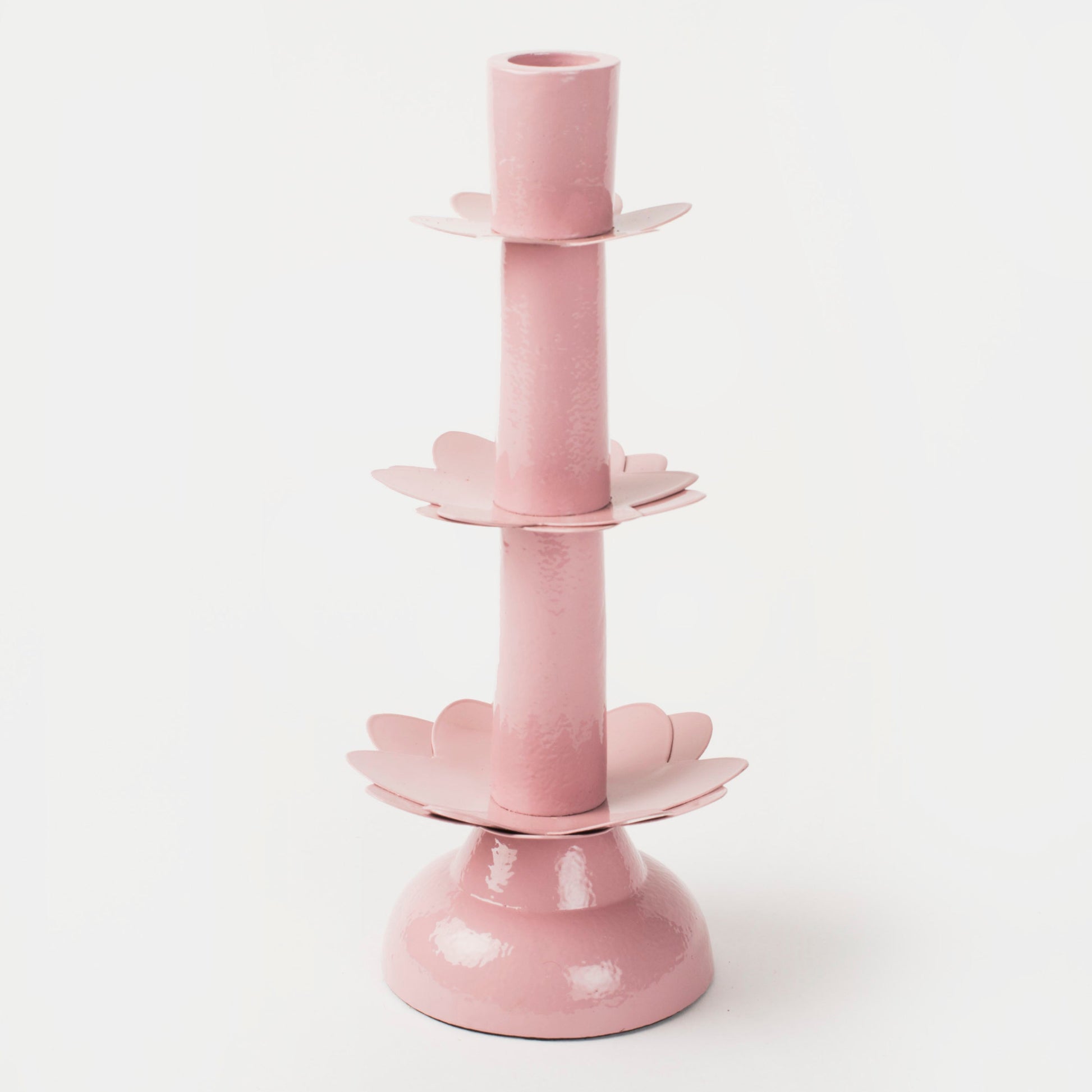 Mela Artisans Lotus Bloom Pink Tapered Candleholder styled with a white taper candle and champagne glasses.