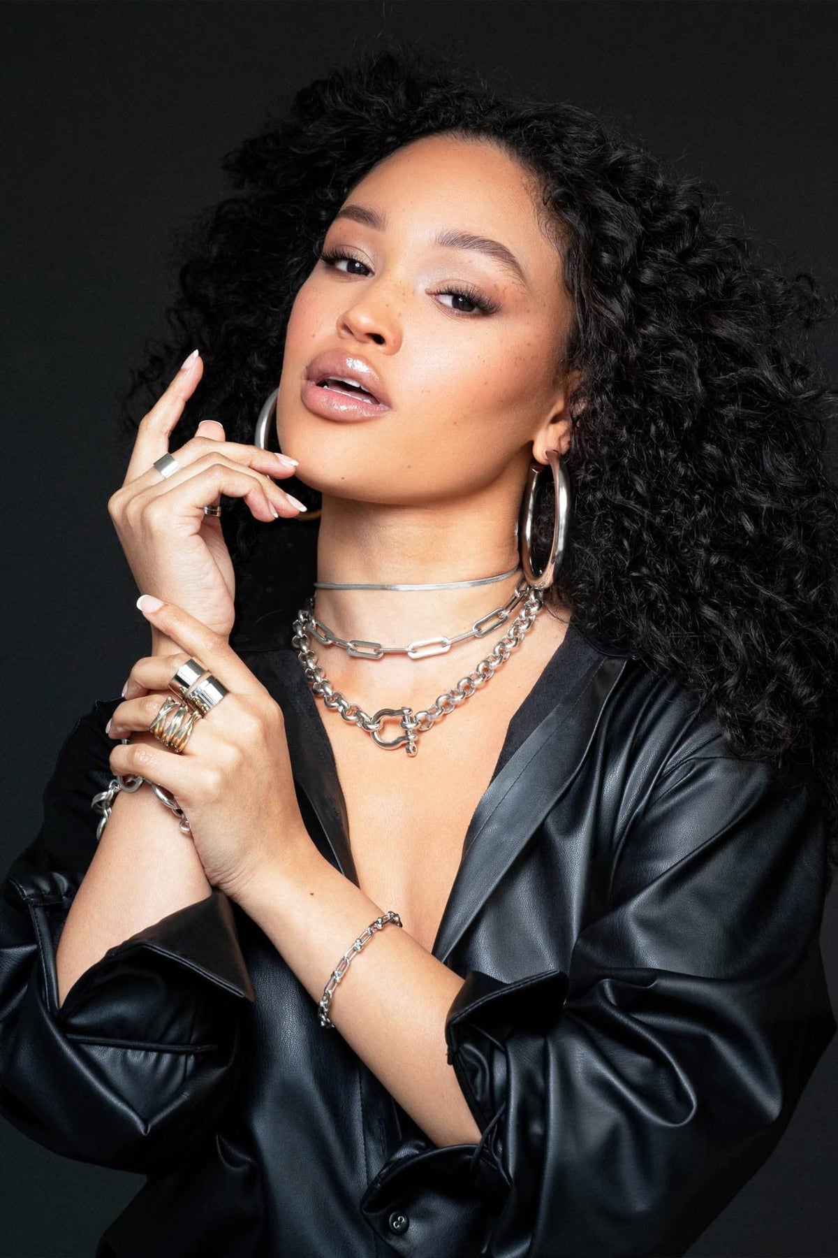 Woman wearing silver jewelry and a black leather jacket showcasing Harley Necklace