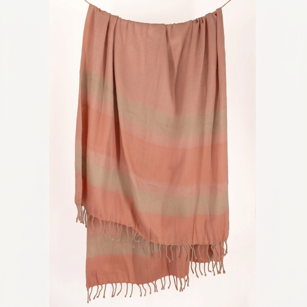 Faded Coral alpaca throw with braided fringe hanging, Kallpa Collection