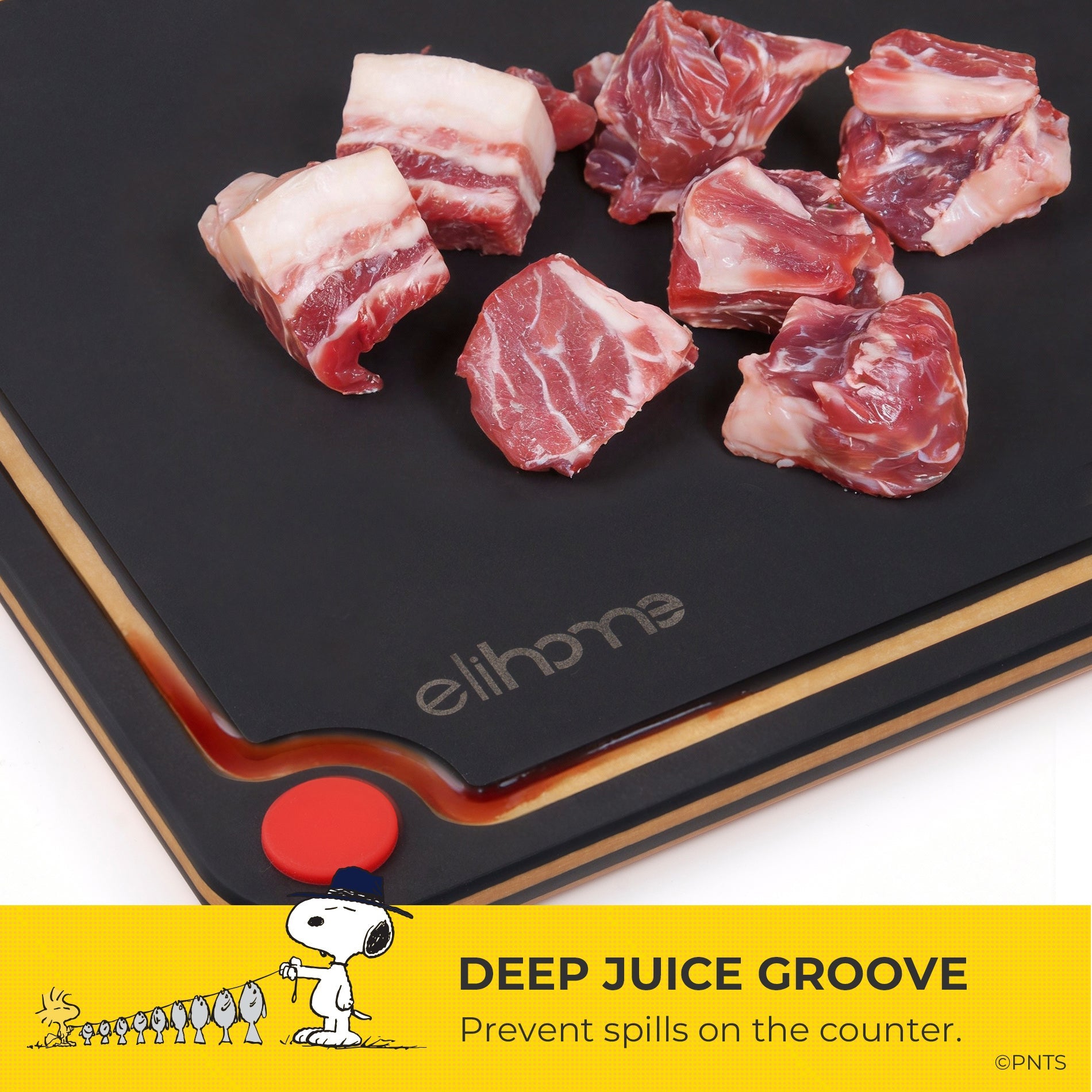 Raw meat on a black cutting board with 'elihome' branding, featuring a deep juice groove.