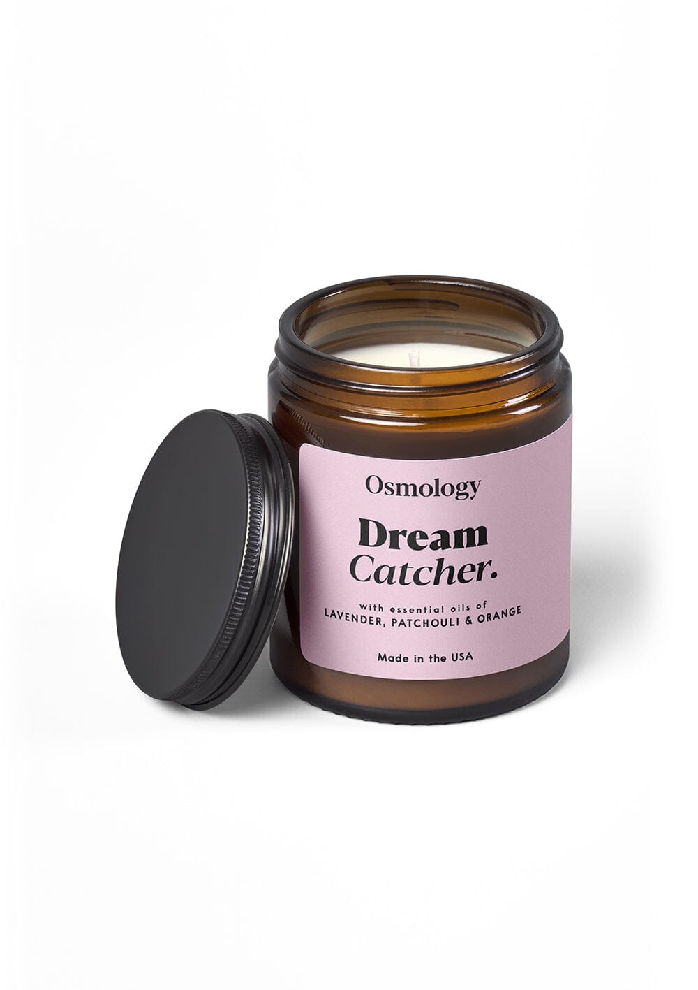 Osmology Dream Catcher jar candle with open lid, with cream background