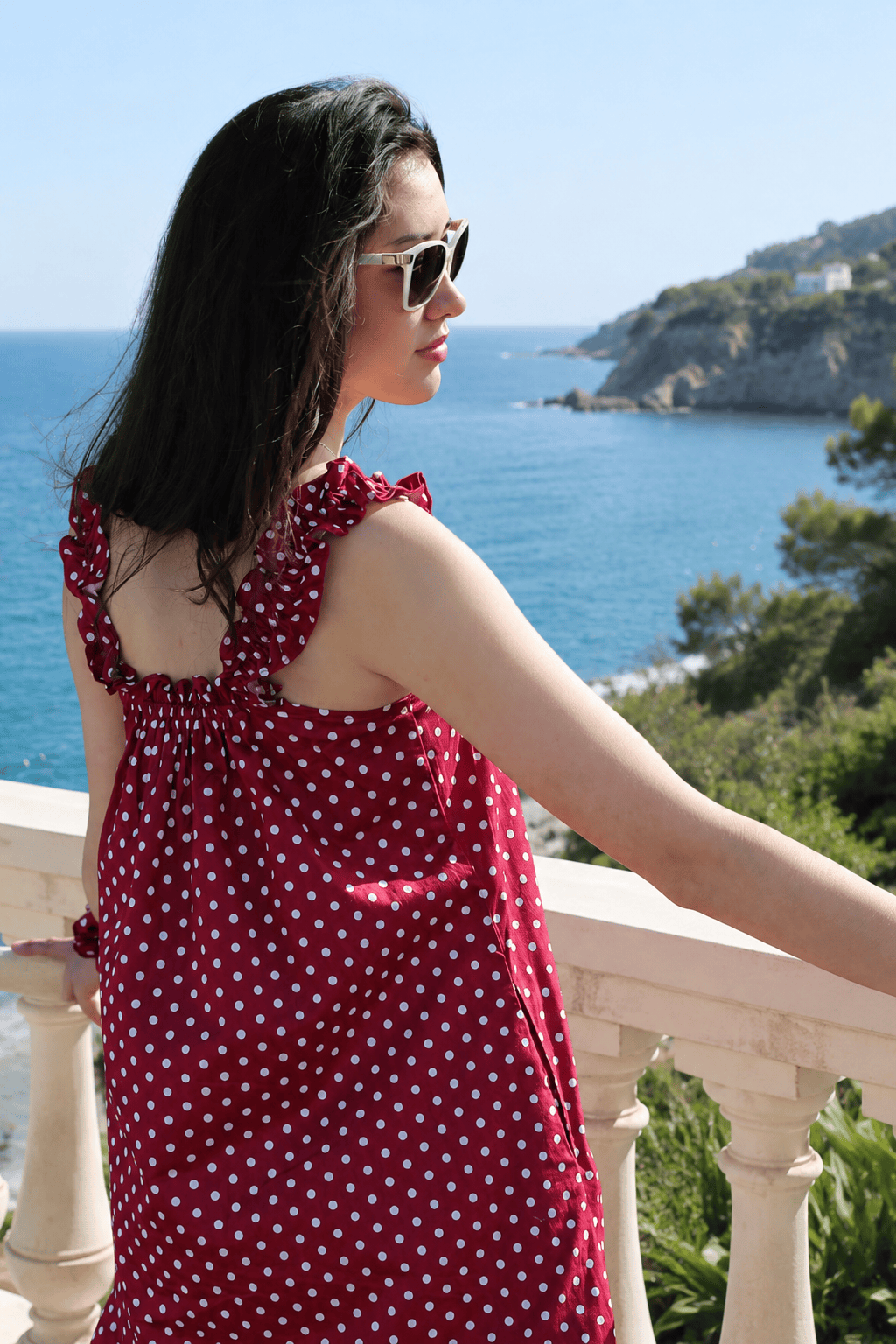 Mila Red back view — women's red and white polka dot cotton mini dress above the knee