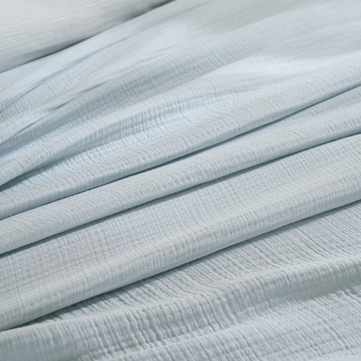 BL-863-9496_5|Close-up of soft light blue muslin gauze blanket texture, highlighting its breathable, lightweight feel for ultimate comfort.