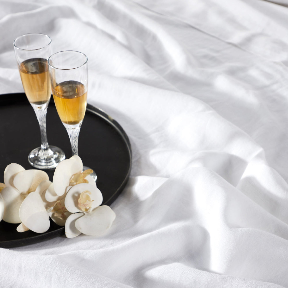 KSS-514-7880_2|Relaxed white 100% pure linen sheets and pillowcases draped on a bed, showcasing softness and natural texture. Eco-friendly.