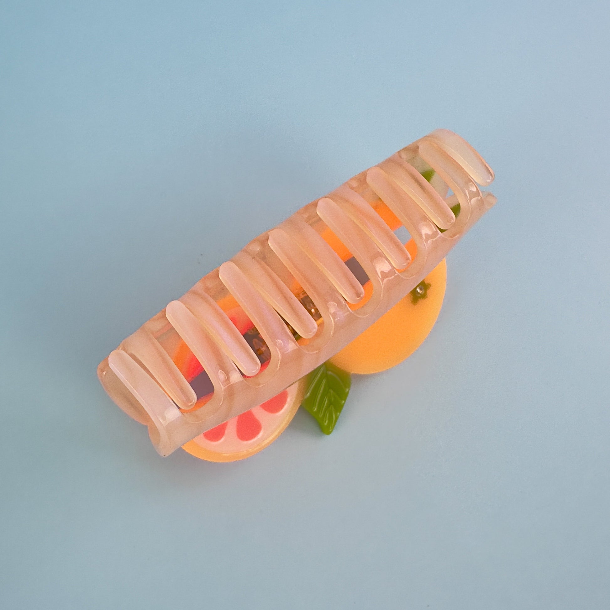 California pomelos orange juicy citrus hair claw clip from Centinelle. Handmade on cellulose acetate, with splice technique, exquisite miniature details and crystals, that are tied directly to its value and make them unique and special. 