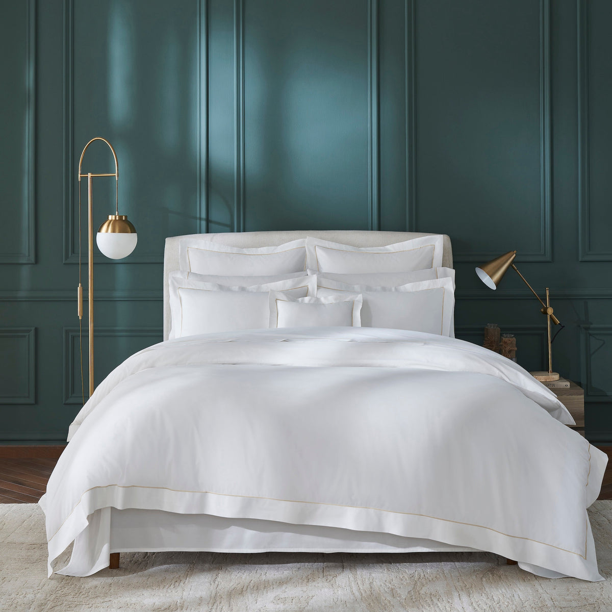 DT-056-9092_4|Stacked luxurious white duvet cover and pillow shams with elegant golden trim. Premium quality bedding product shot.