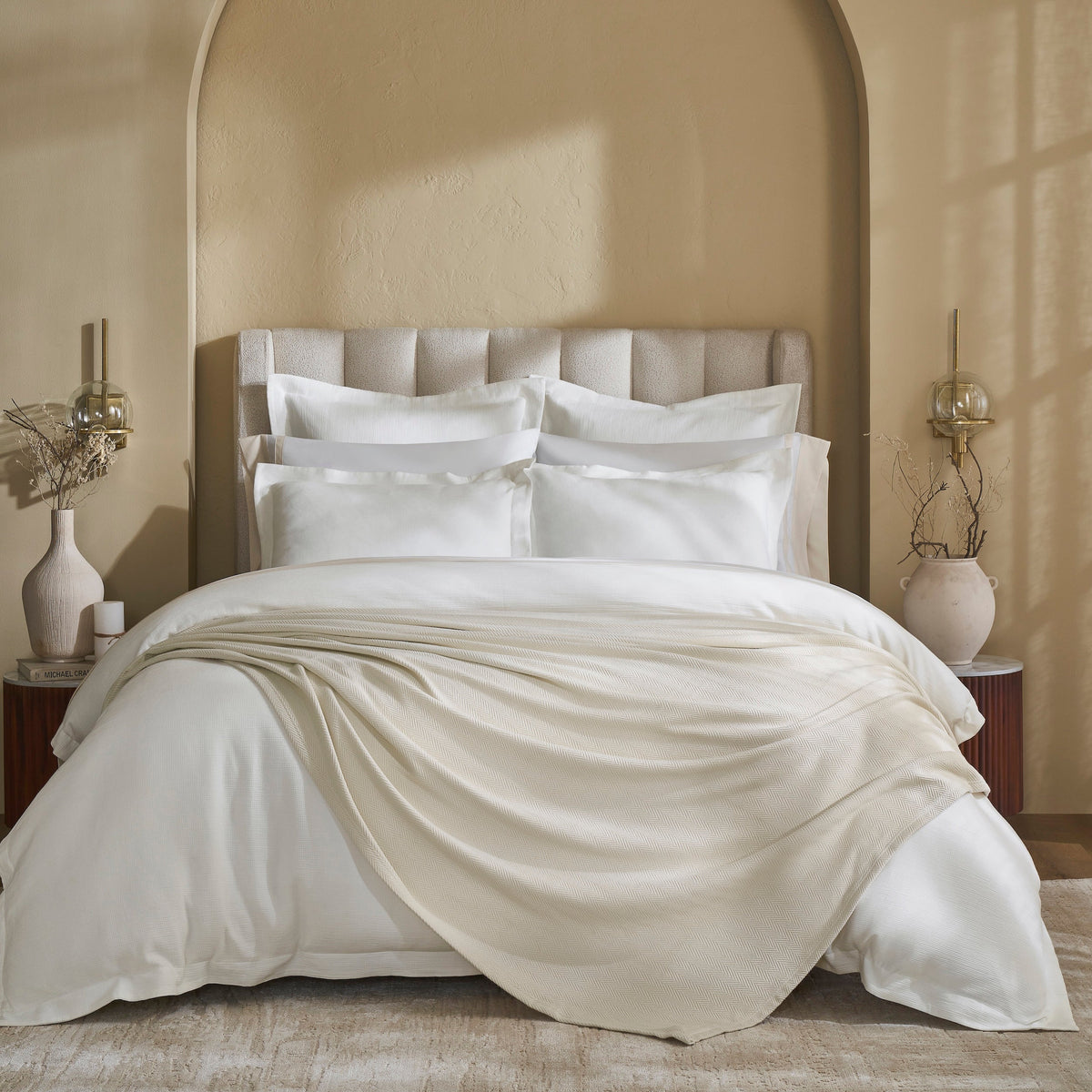 BL-866-11096_1|Cream textured knit blanket draped on white bedding, adding cozy luxury to a neutral bedroom. Perfect for warmth and style.