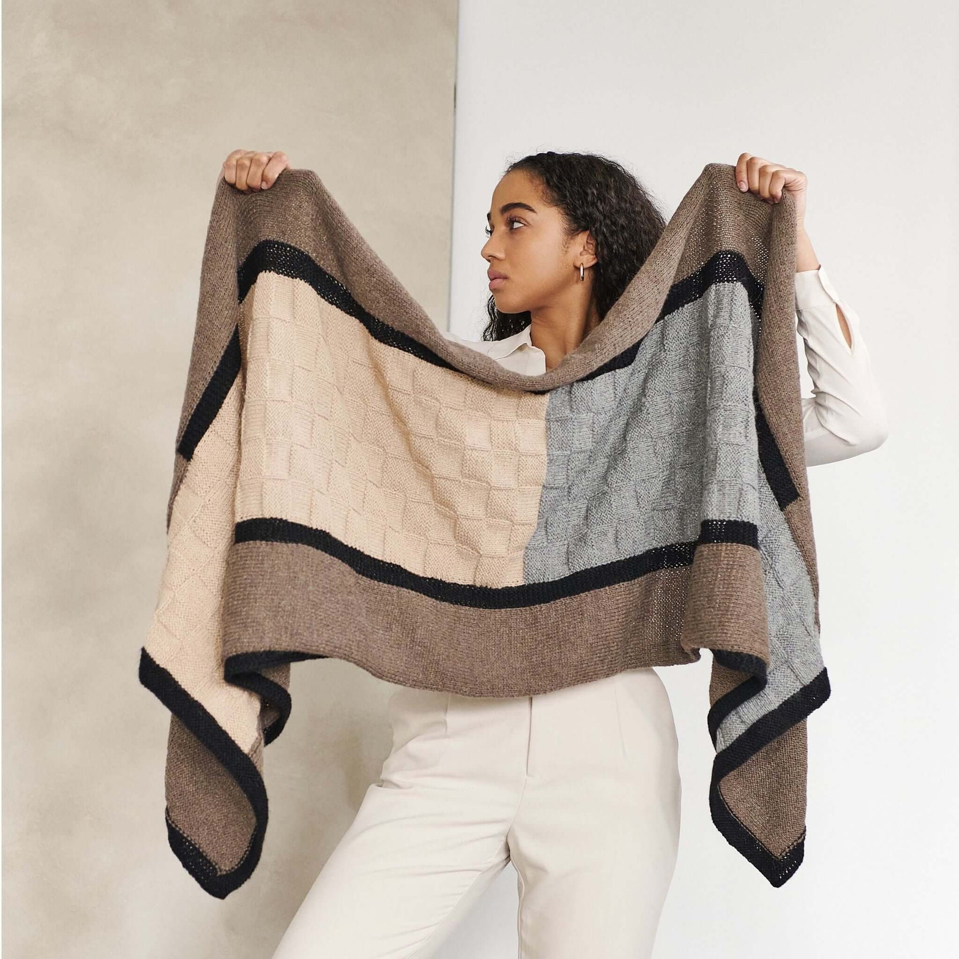 Muhu Brown Gray Hand Knitted Peruvian Alpaca Blanket / Large Plush Scarf displayed by a woman wearing light-colored pants.
