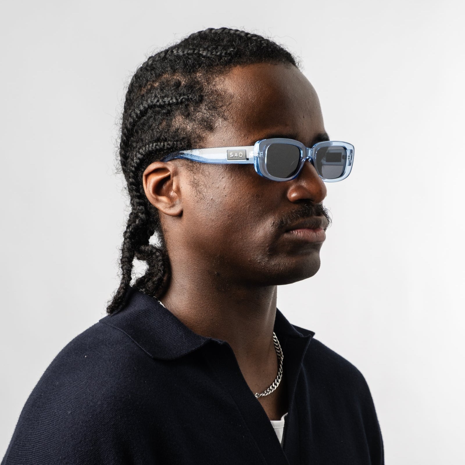 Male wearing Sad Eyewear Bouquet rectangle sunglasses in arctic blue with black tinted lenses