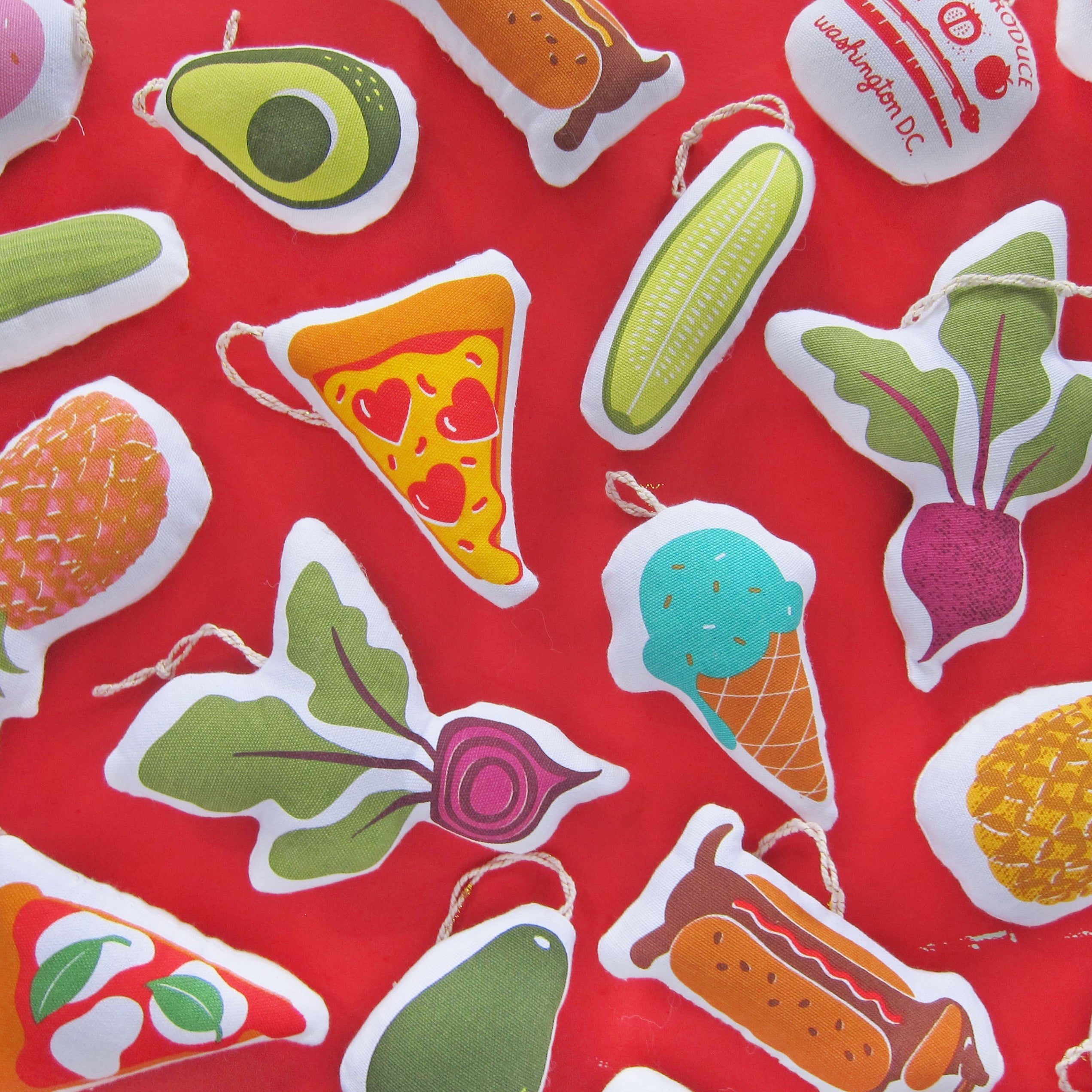 Hot dog ornament pictured with an array of other Neighborgoods holiday ornaments