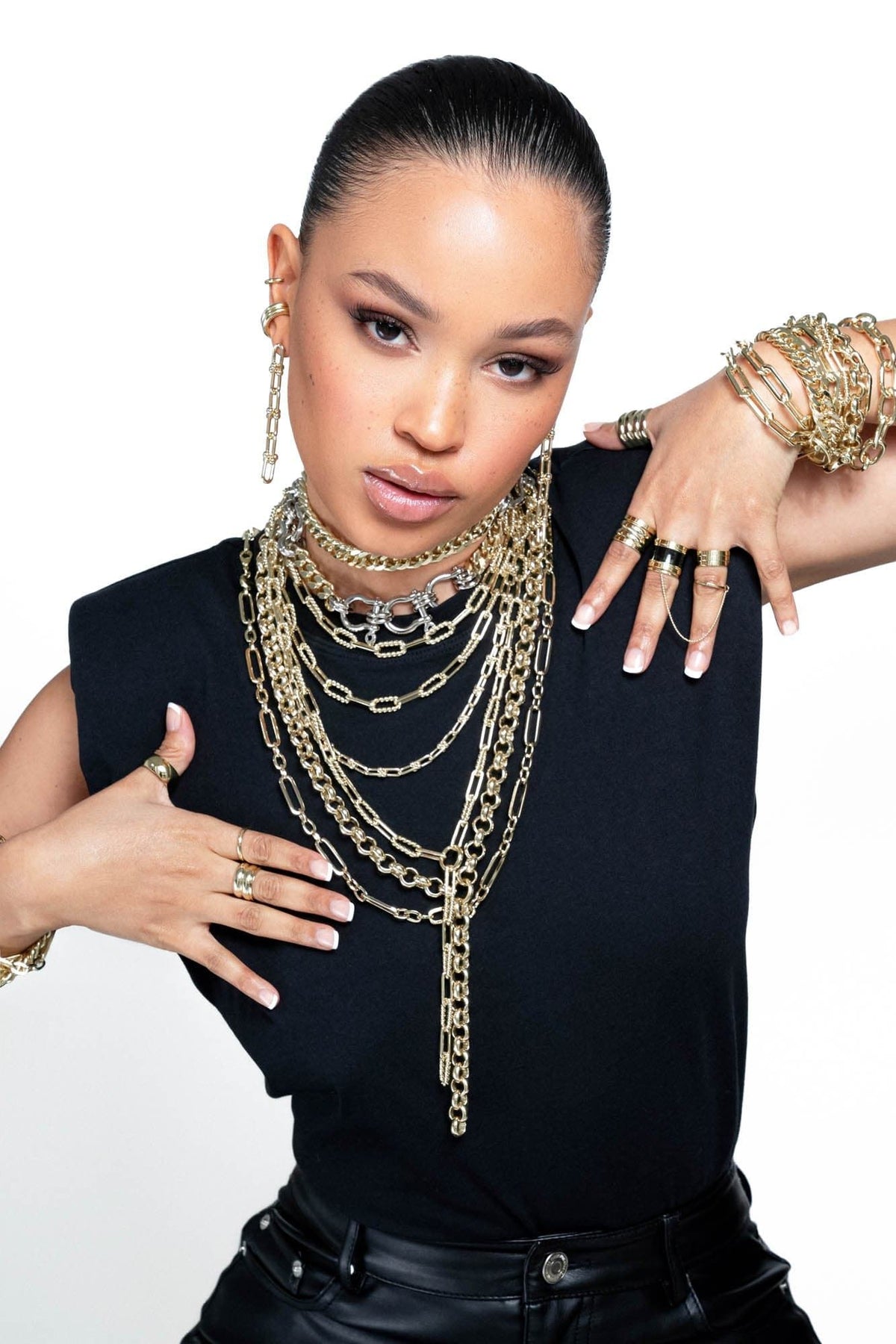 Woman wearing gold jewelry showcasing Dean Lariat Necklace style and elegance