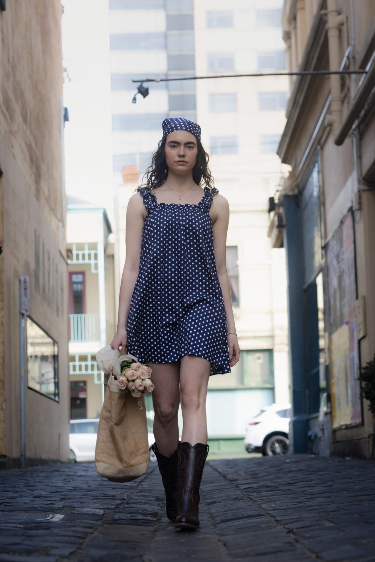 Mila Navy Dot side view — relaxed cotton mini dress above the knee in navy