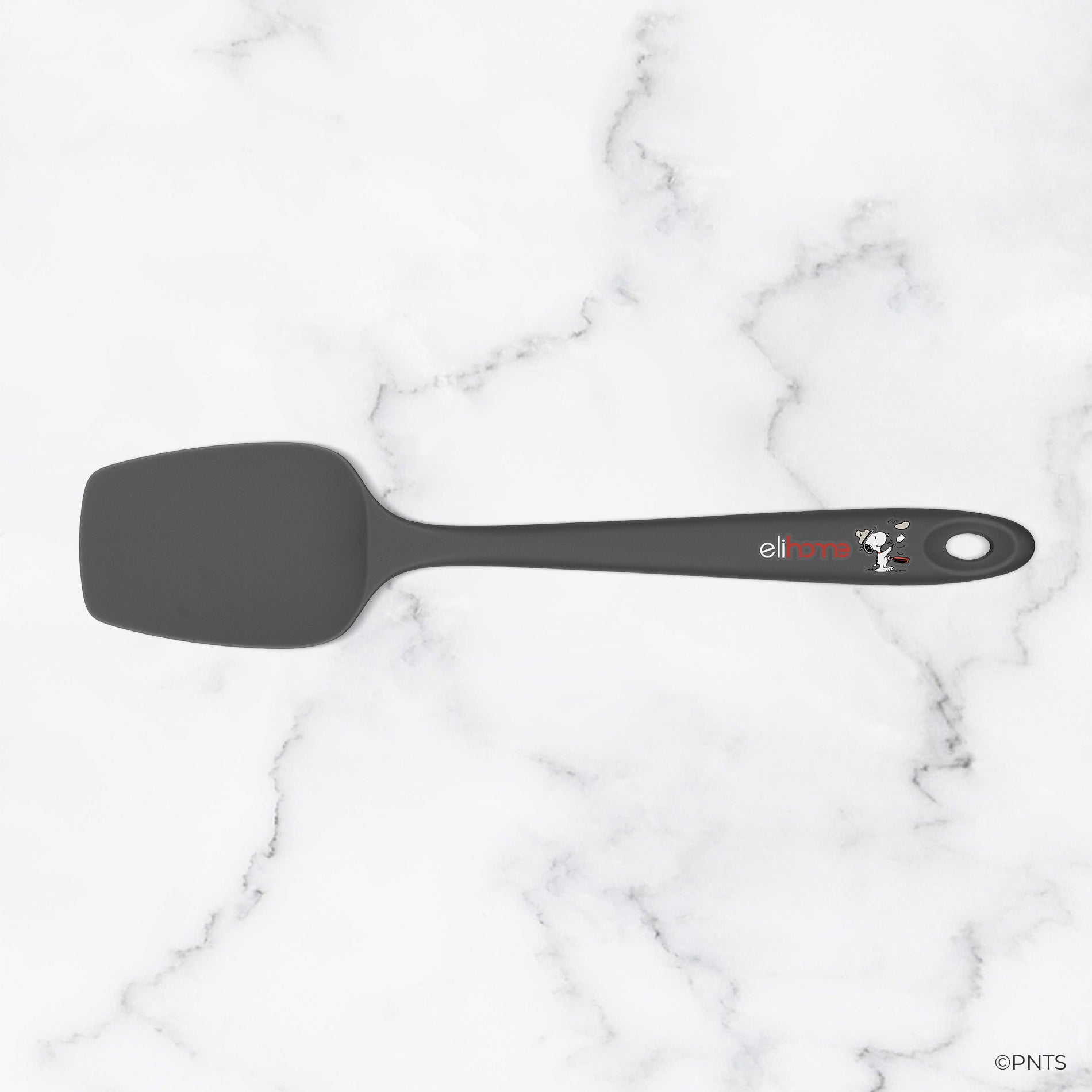 Black spatula with a brand logo on a marble background