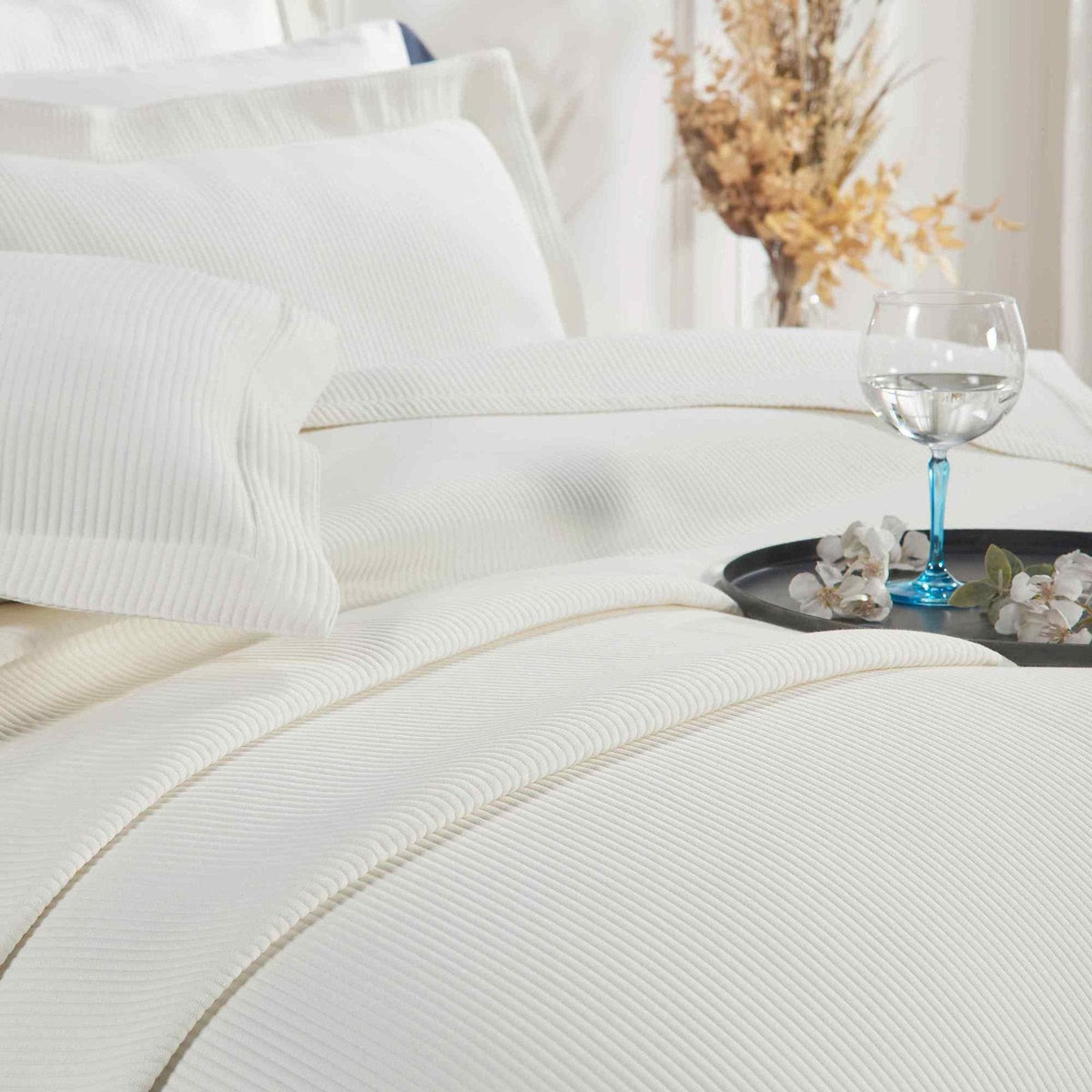 CL-192-9496_4|Soft white striped coverlet detailed on a bed, offering a luxurious and inviting texture for premium hotel-quality bedding.