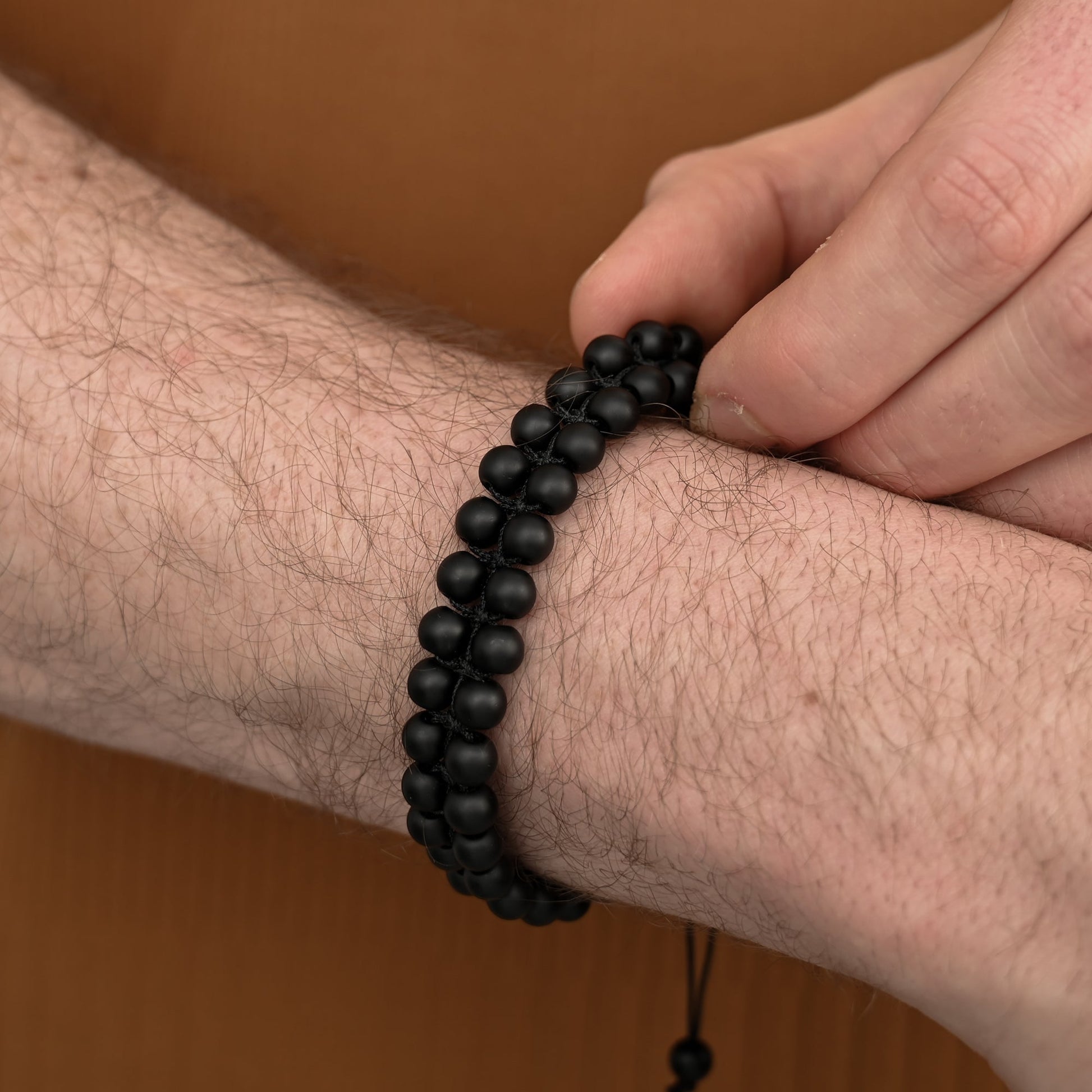 Photo of a man wearing beaded bracelet, black beaded bracelets for men,  online gift shopping, jewelry store near me