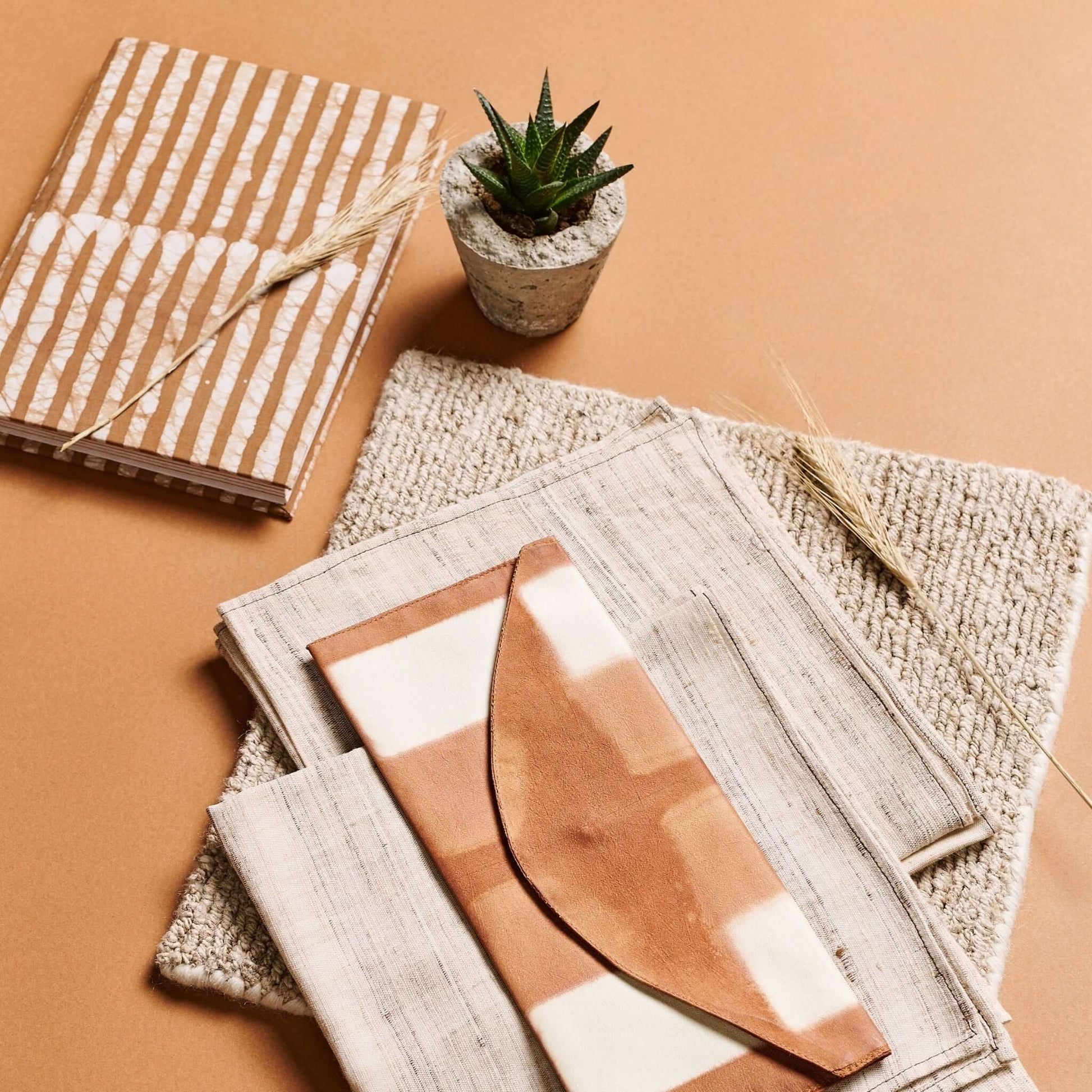 Oak Brown Zero Waste Handmade Artisanal Journal surrounded by natural textures and a small succulent plant.