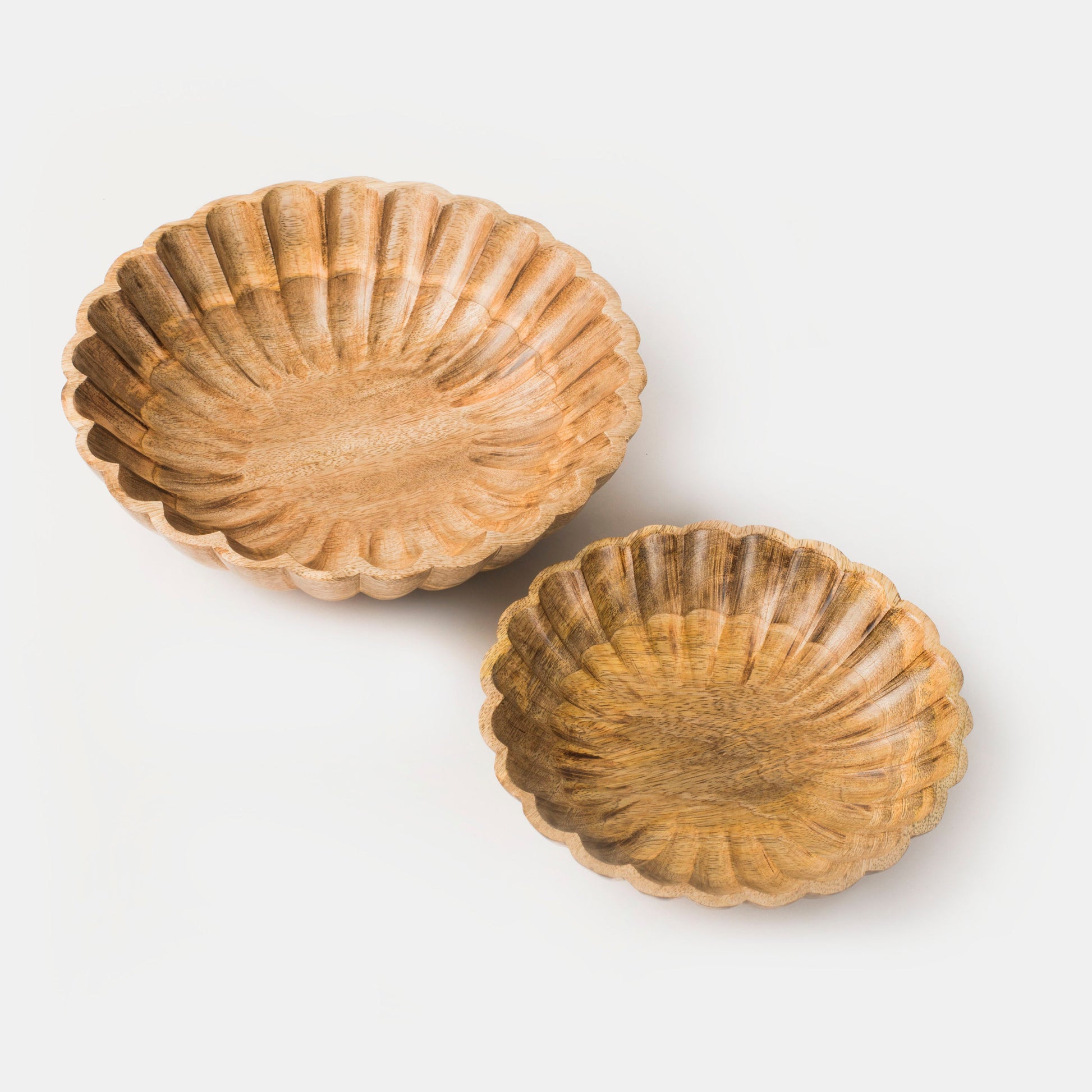 Set of two hand-carved scalloped mango wood bowls nested together